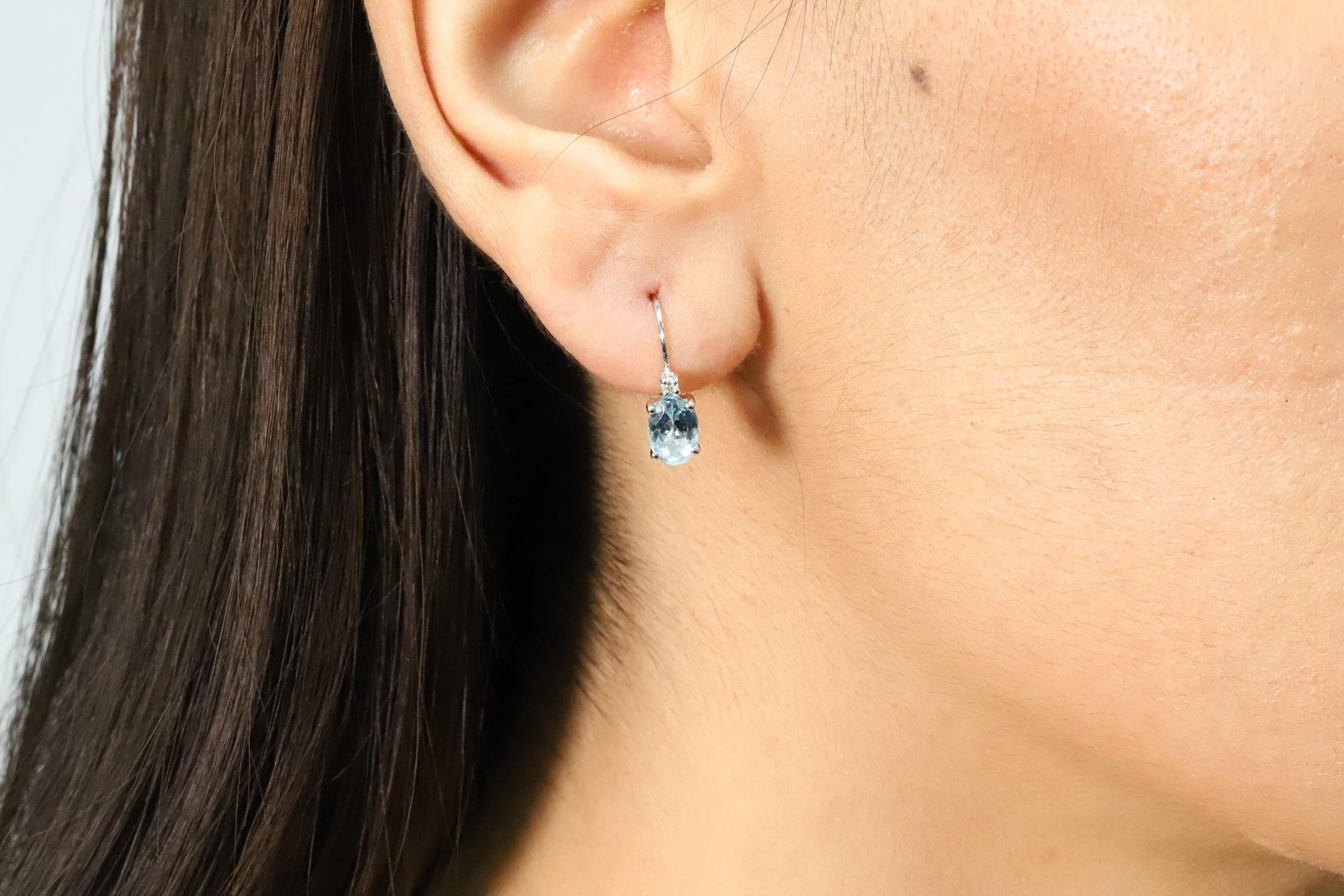 Decorate yourself in elegance with this Earring is crafted from 14K White Gold by The Loop Club Earring. This Earring is made up of 5X7 Oval-Cut prong setting Genuine Aquamarine (2 pcs) 1.48 Carat and Round-Cut prong setting Diamond (2 pcs) 0.05