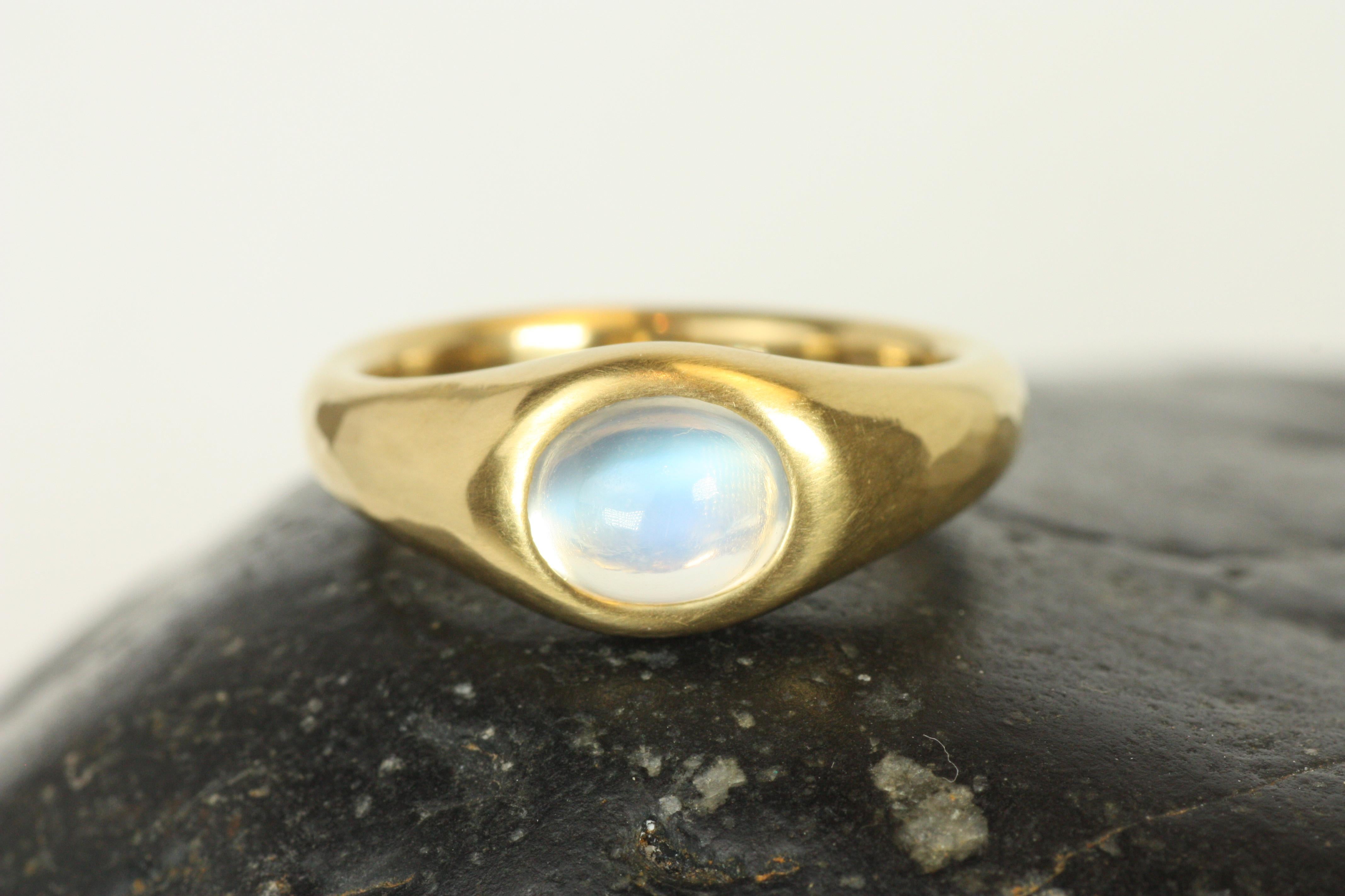 This radiant 1.50ct rainbow moonstone gleams with ethereal flashes of blue and white, set in luxurious 22K yellow gold. The cabochon cut highlights the stone's natural beauty and its mystical play of light, while the gypsy setting ensures both