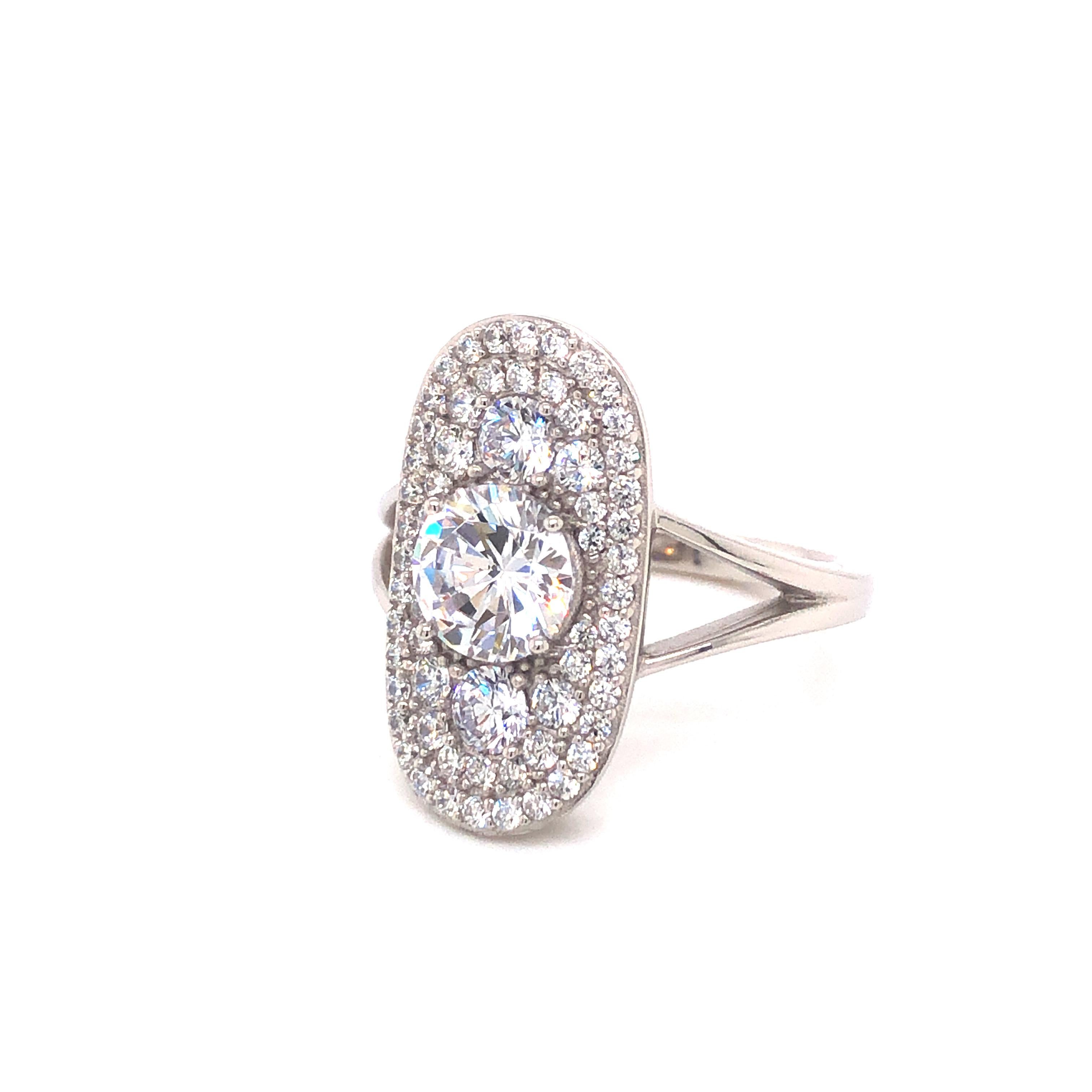 Part of our Deco Collection, and inspired by the roaring twenties, this show stopping design has the timeless appeal of this iconic decade. 

Unusual oval design housing one large round brilliant cut cubic zirconia surrounded by a shimmering array