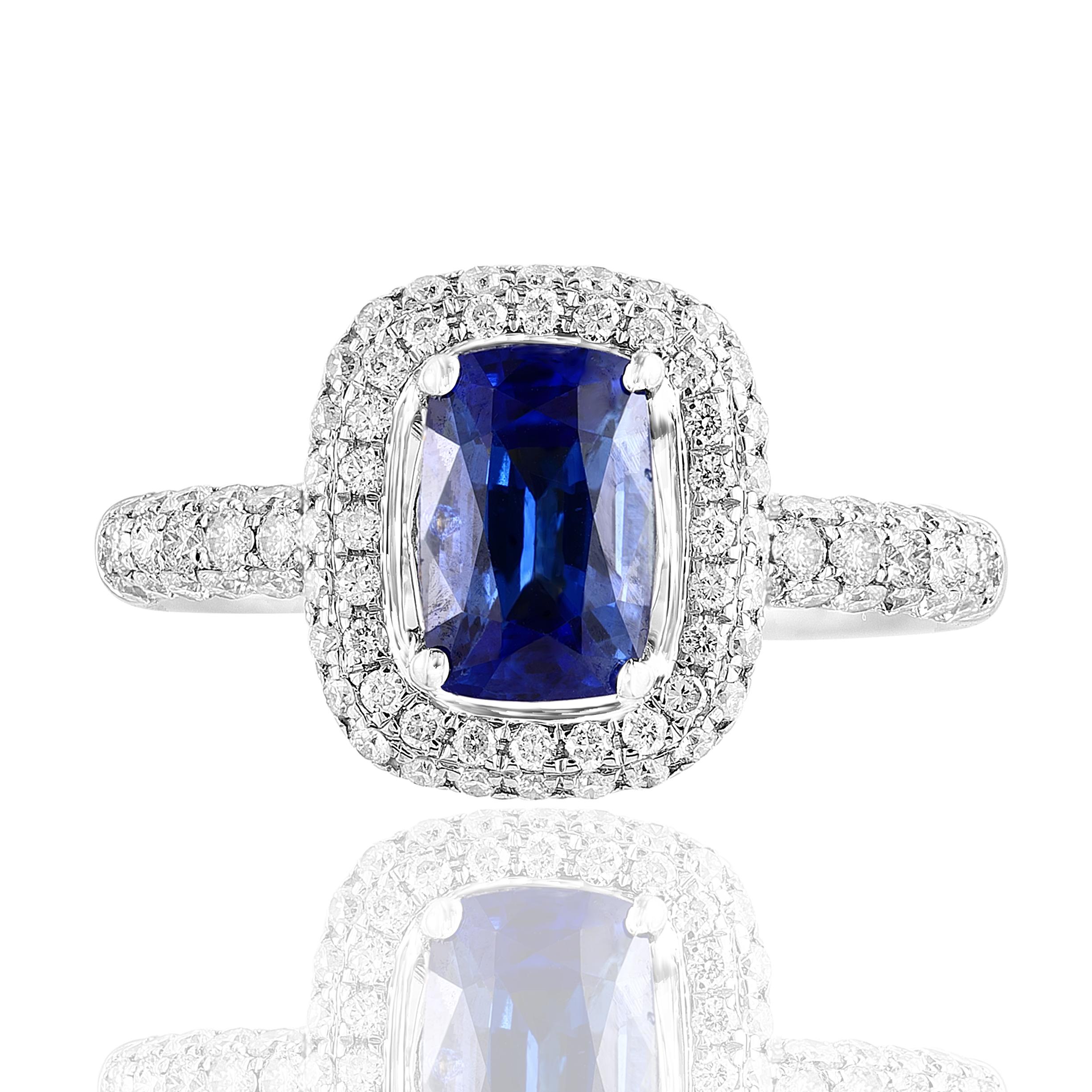 1.50 Carat Cushion Shape vibrant Blue Sapphire and Diamond Cocktail Ring in 18K White Gold. The Center stone is surrounded by 2 rows of 104 Brilliant cut Round Diamonds with a Total weight of 0.75 carats of total weight. 
A classic Cocktail Ring