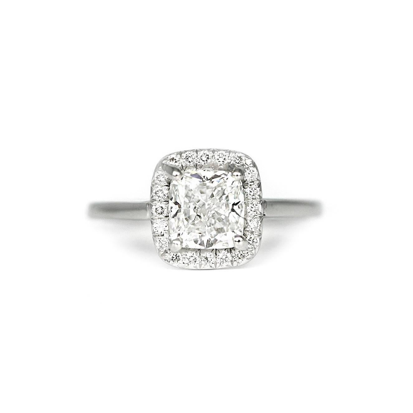 Cushion cut diamond weighing 1.50 carats with a Gia Certificate 512138730
F/ VS 2. Set in a platinum halo mounting with  20 diamonds weighing .15 carats. Size 6 1/4, easily resized. 