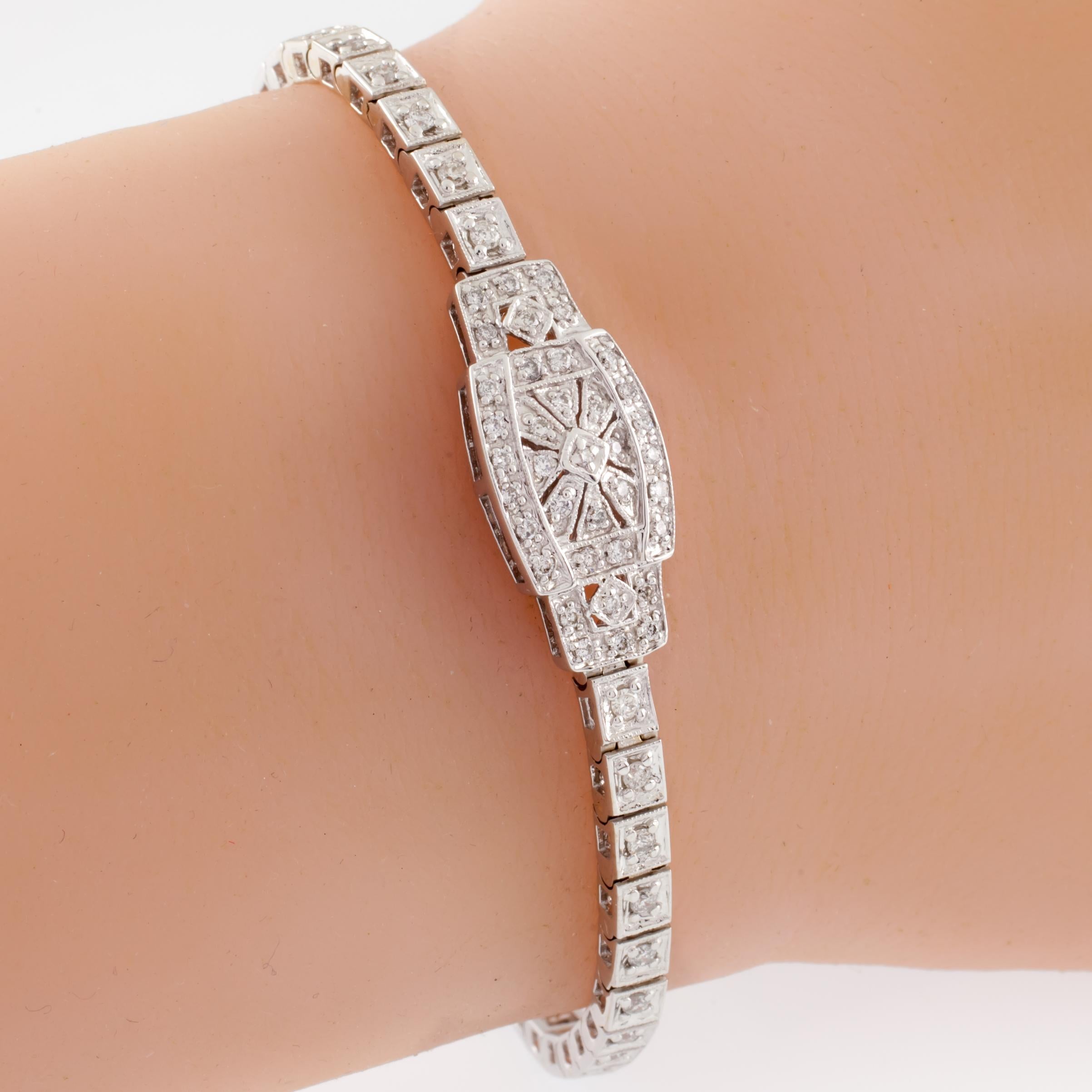 Gorgeous Art Deco-inspired bracelet
Features Pave-Set Round Diamond on Band
Round Diamonds Set in Beautiful Sunburst Pattern on Plaque
Total Diamond Weight = 1.00 ct
Average Color = G - H
Average Clarity = SI1 - VS
Width of Band = 3 mm
Width of