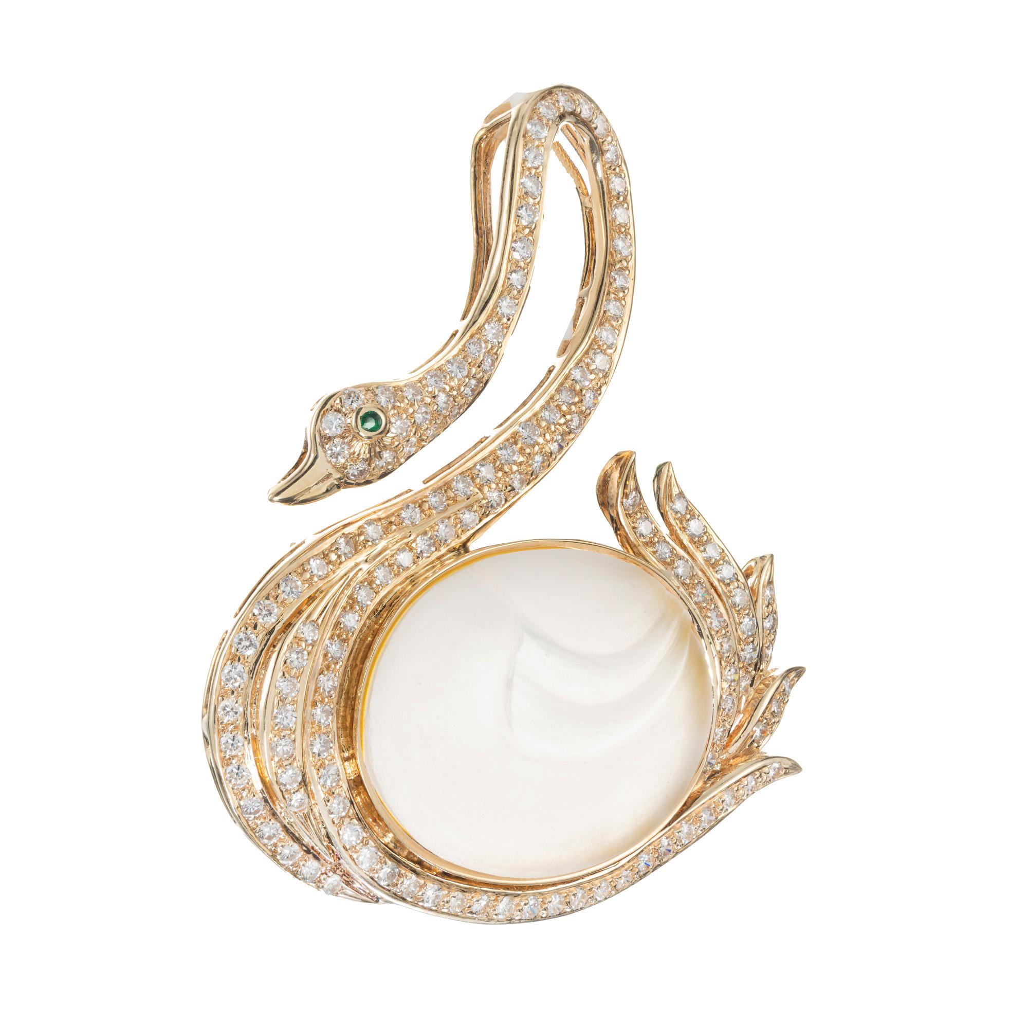 Swan diamond and emerald brooch. Bezel set oval carved Angel Skin quartz in a beautifully crafted Swan setting accented with 133 round cut diamonds and 1 round cut emerald eye.  

1 oval carved angel skin quartz
133 round diamonds, H-I VS SI approx.