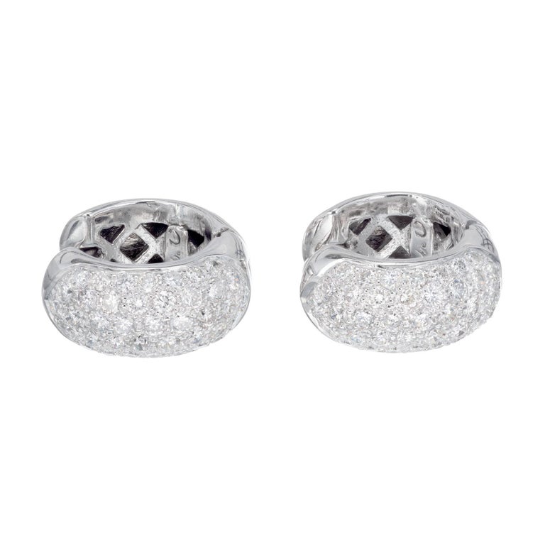 18k white gold huggie hoop earrings Pave set with 78 full cut diamonds.

78 full cut diamonds, approx. total weight 1.50cts, F, VS2
18k White Gold
Tested: 18k
10.5 grams
Unknown hallmark
Top to bottom: 15.06mm or .59 inch
Width: .28 inch or 7.25mm