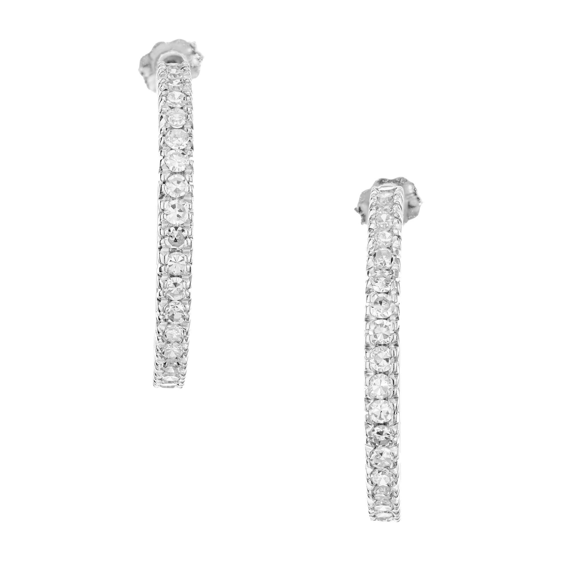 1960's Diamond Platinum hoop earrings. Each hoop is encrusted with 31 brilliant round-cut diamonds, totaling 1.50 carats, creating a stunning sparkle. The platinum setting adds a touch of elegance and durability to these earrings, The classic hoop