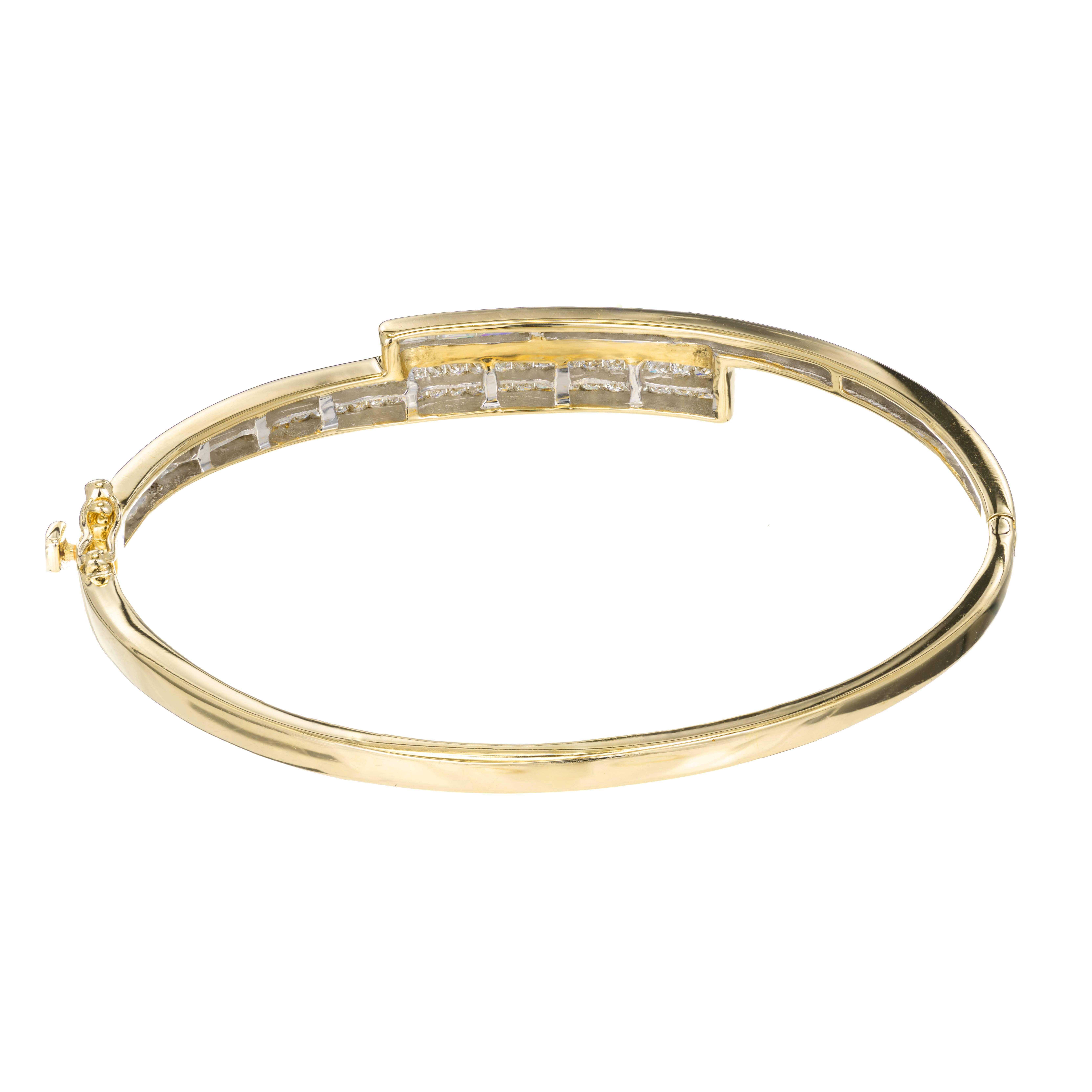 Hinged diamond by pass style bangle bracelet with bright sparkly diamonds. Set in 14k yellow gold with secure hinge and catch with side lock safety.

60 princess cut invisible set diamonds and 15 straight baguette cut diamonds. Color G to H Clarity