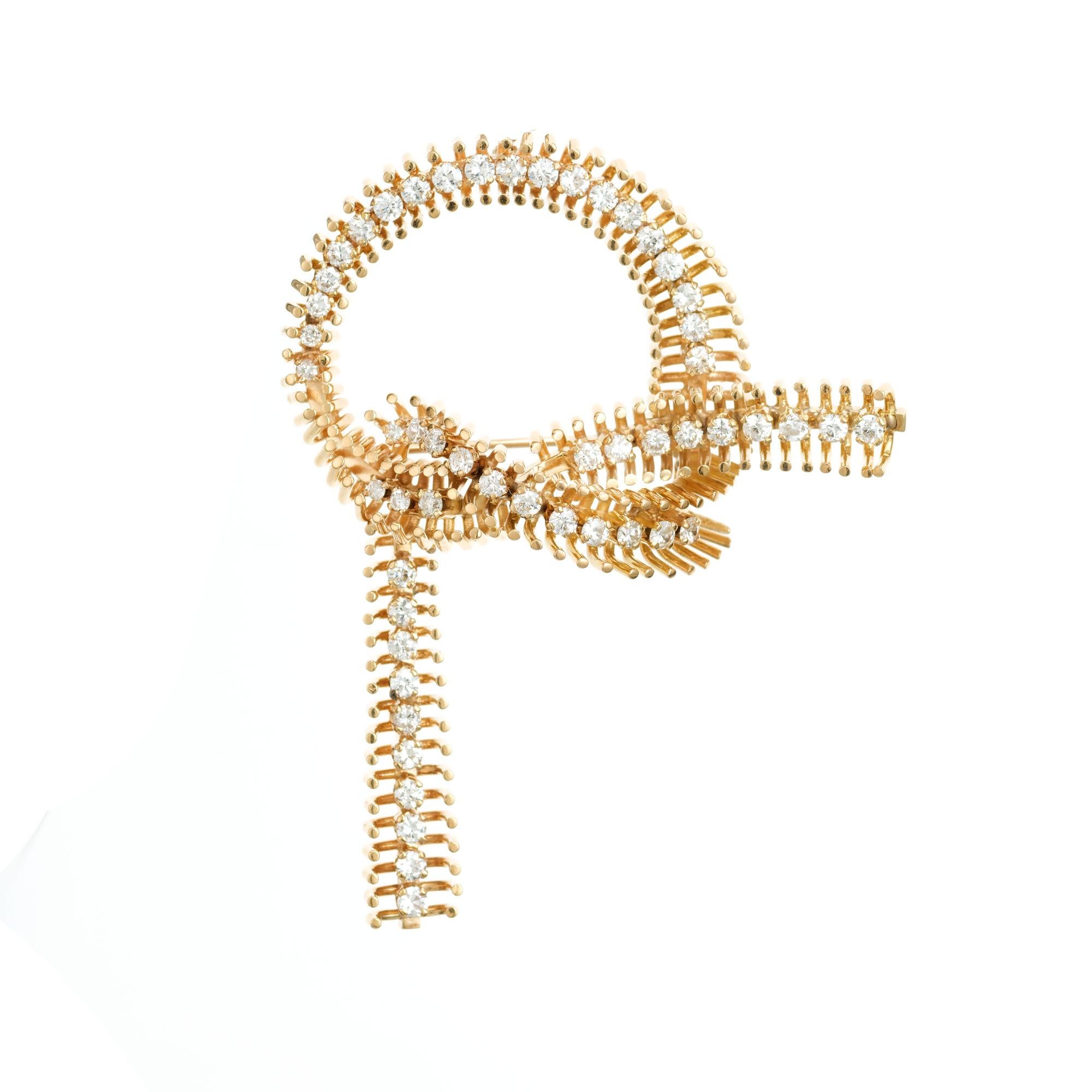 Retro 1940's 14k yellow gold bow brooch pendant. 53 full cut round diamonds in a bow design. Loop at top for it to be worn as a pendant.  

53 full cut diamonds, approx. total weight 1.50cts, F, VS
14k Yellow Gold
Tested: 14k pink gold
32.5