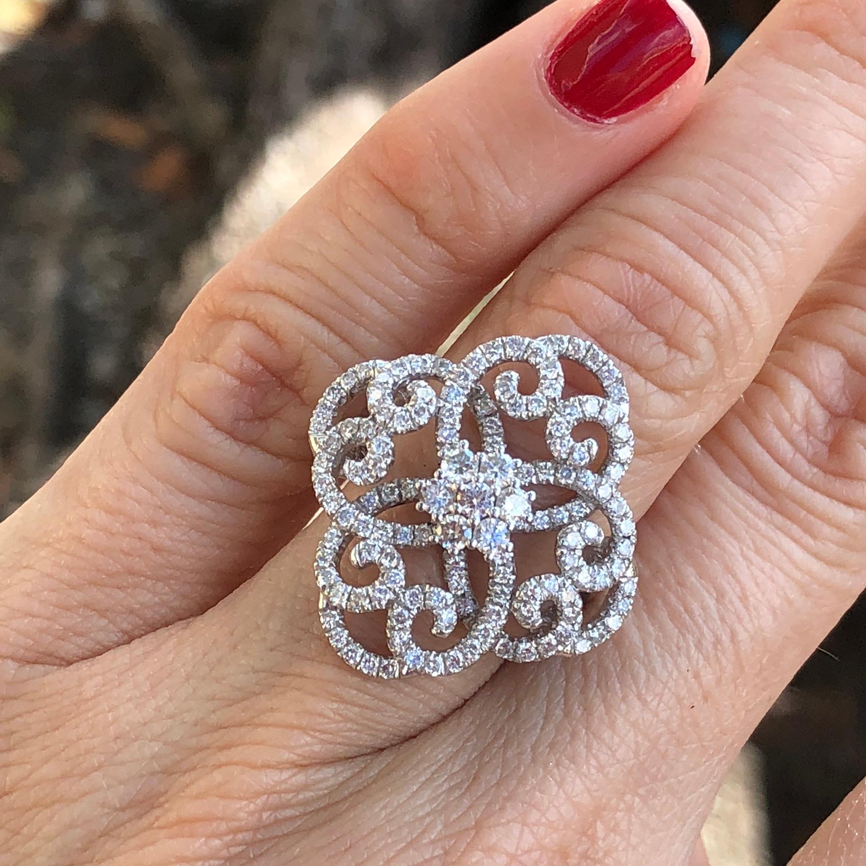 14 karat white gold diamond clover swirls statement ring with diamond cluster center. 

Features
14K white gold
1.50 carat total weight in diamonds
Ring size 6.5 