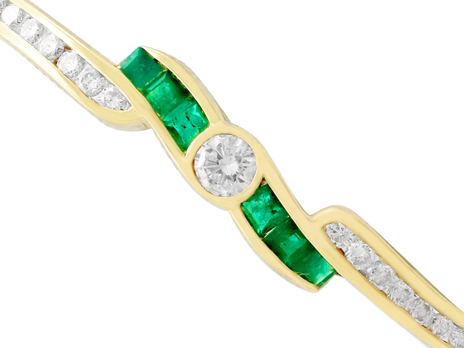 An impressive contemporary 1.50 Carat emerald and 1.36 Carat diamond, 18 karat yellow gold twist design bangle; part of our diverse gemstone jewelry collections.

This exceptional, fine and impressive emerald and diamond bangle has been crafted in