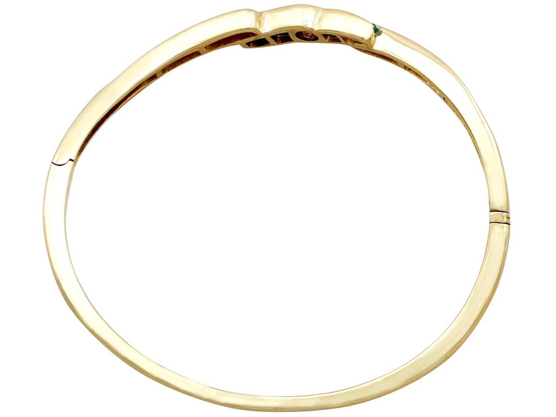 Contemporary 1.50 Carat Emerald and 1.36 Carat Diamond Bangle in 18K Yellow Gold For Sale