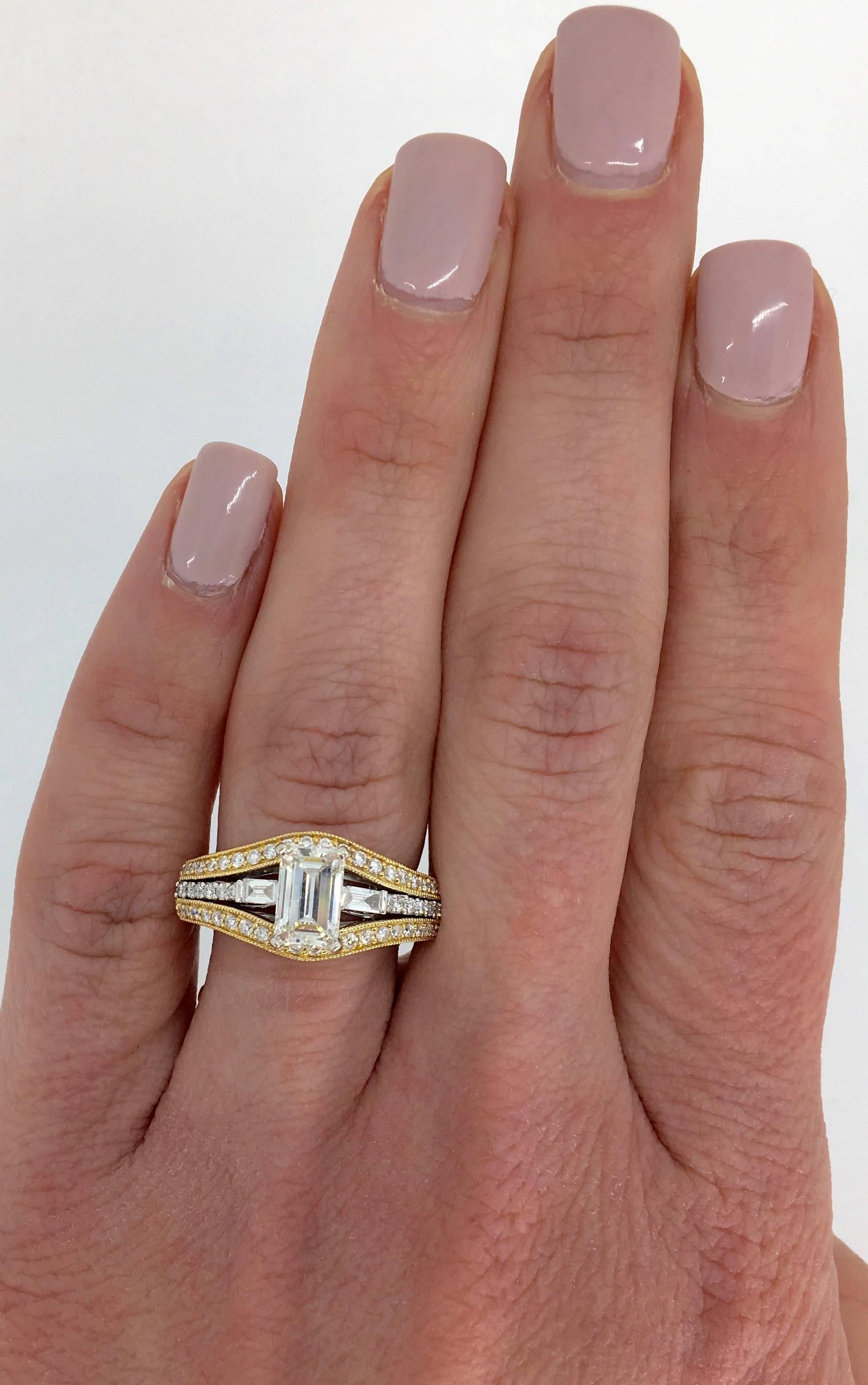 Unique two-tone diamond engagement ring with a 1.00ct Emerald cut diamond in the center, and 0.50ctw of Baguette and Round Brilliant cut diamonds surrounding it. 

Center Diamond Carat Weight: 1.00CT
Center Diamond Cut: Emerald Cut 
Center Diamond