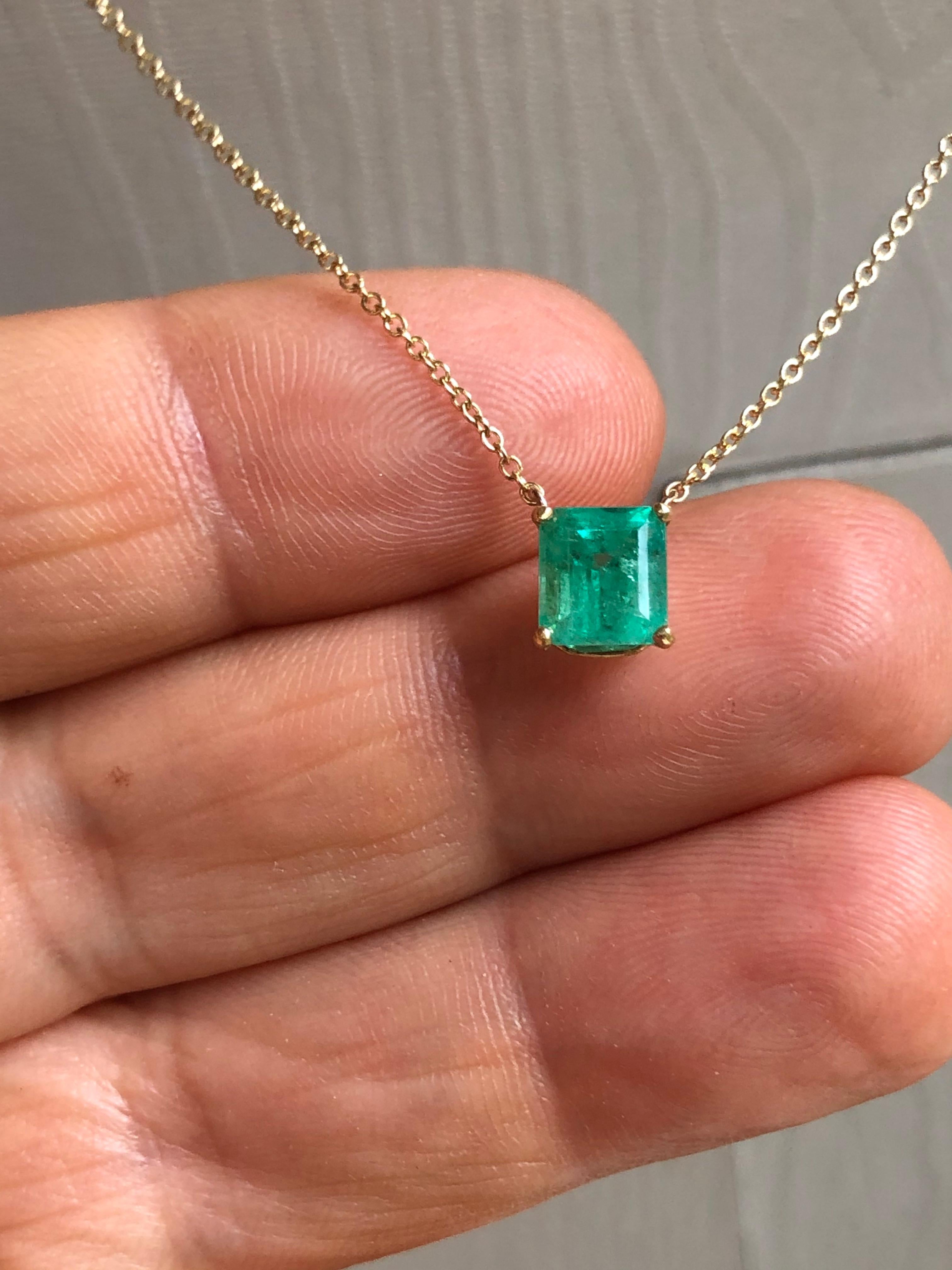 This drop solitaire pendant necklace features an emerald l cut,  medium green natural  Colombian emerald weighing 1.50 carats. Set in 18K yellow Gold setting and fixed to a 18 Inches long, Gold chain.  Very style good for every day wear!
