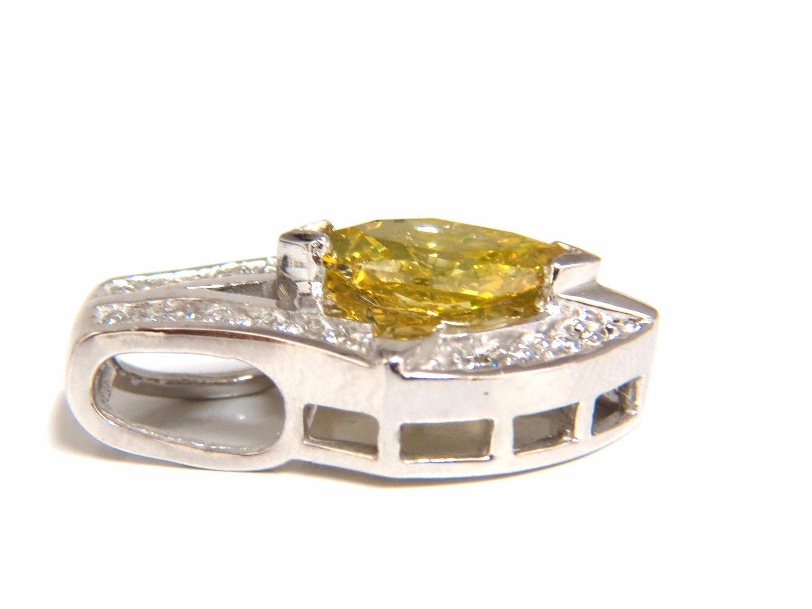 Yellow Shield Deco

1.00ct. enhanced yellow diamond pendant.

 Full cut brilliant Marquise

 I-1  Clarity. 

Fancy Yellow color.

.50ct. Natural white diamonds

G-color Vs-2 clarity.

14kt. white gold 

Overall: .8 x .5 inch

3.3 grams.