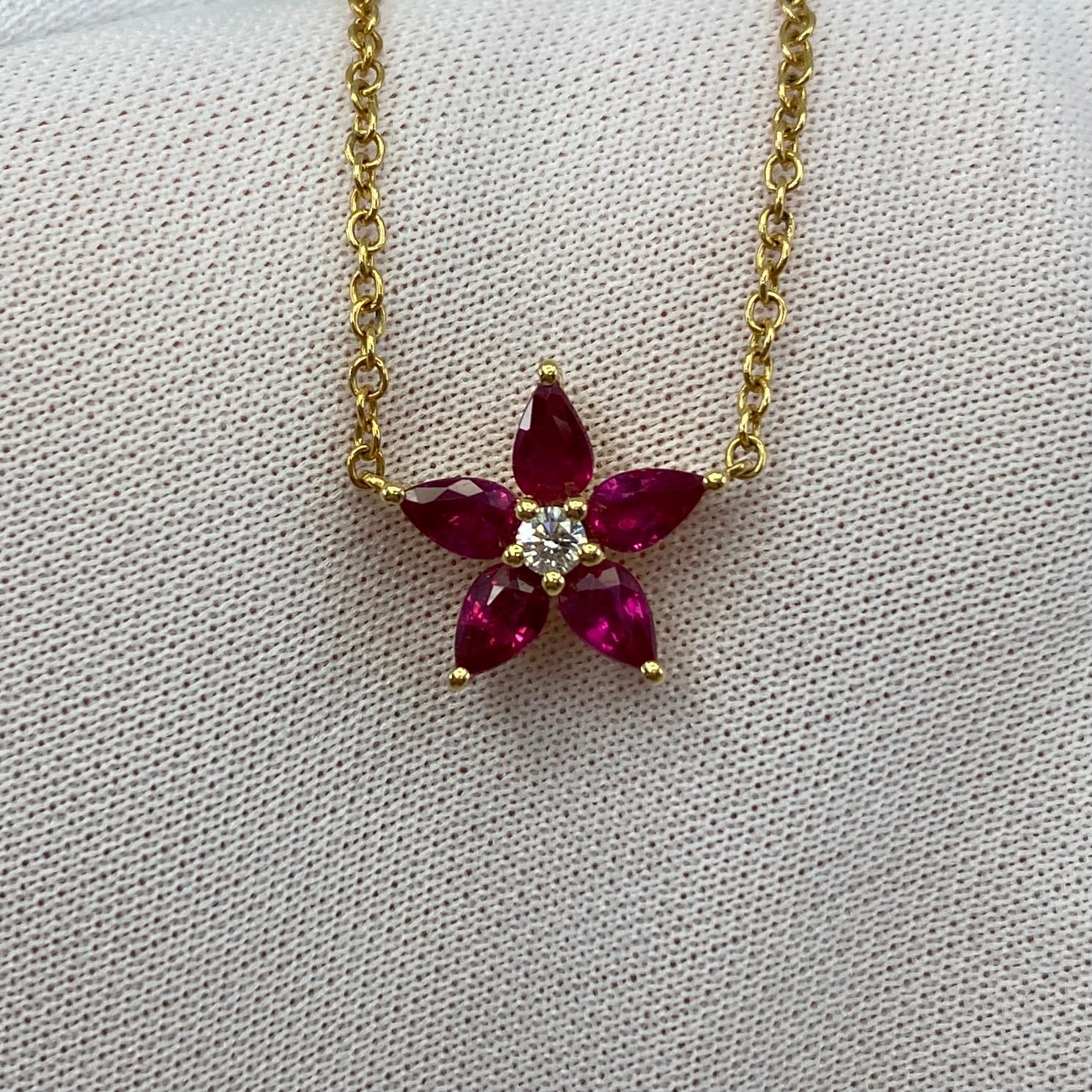 Fine Deep Red Ruby & Diamond 18k Yellow Gold Flower Necklace.

Stunning 1.50 total carat pear cut rubies with a fine deep red colour and excellent clarity. Radiating around a 2.5mm white diamond. G/H colour Si1/2 clarity.
All set in a fine 18k