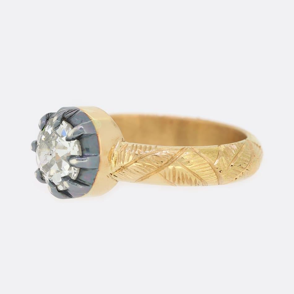 This is a beautiful, 18ct yellow gold, old cut diamond ring. The setting of the ring is in a Georgian style and the band features wonderful foliate detail. The diamond is set in oxidised silver to emphasise its sparkle.

This ring was masterfully