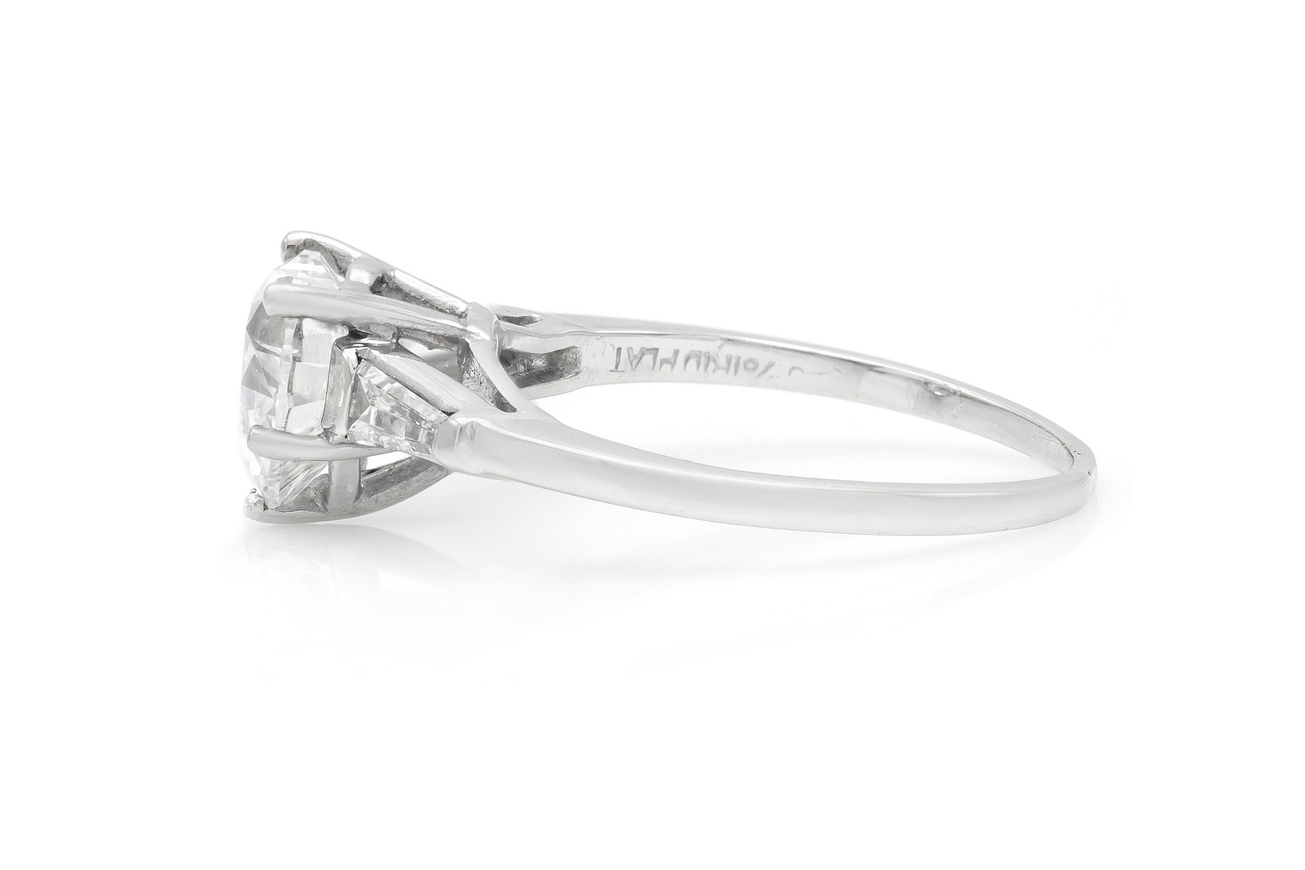 Finely crafted in platinum with a center GIA certified Heart shaped diamond, weighing 1.50 carats.
Color G Clarity SI1
The ring features two tapered baguette cut side diamonds weighing a total of approximately 0.25 carats.