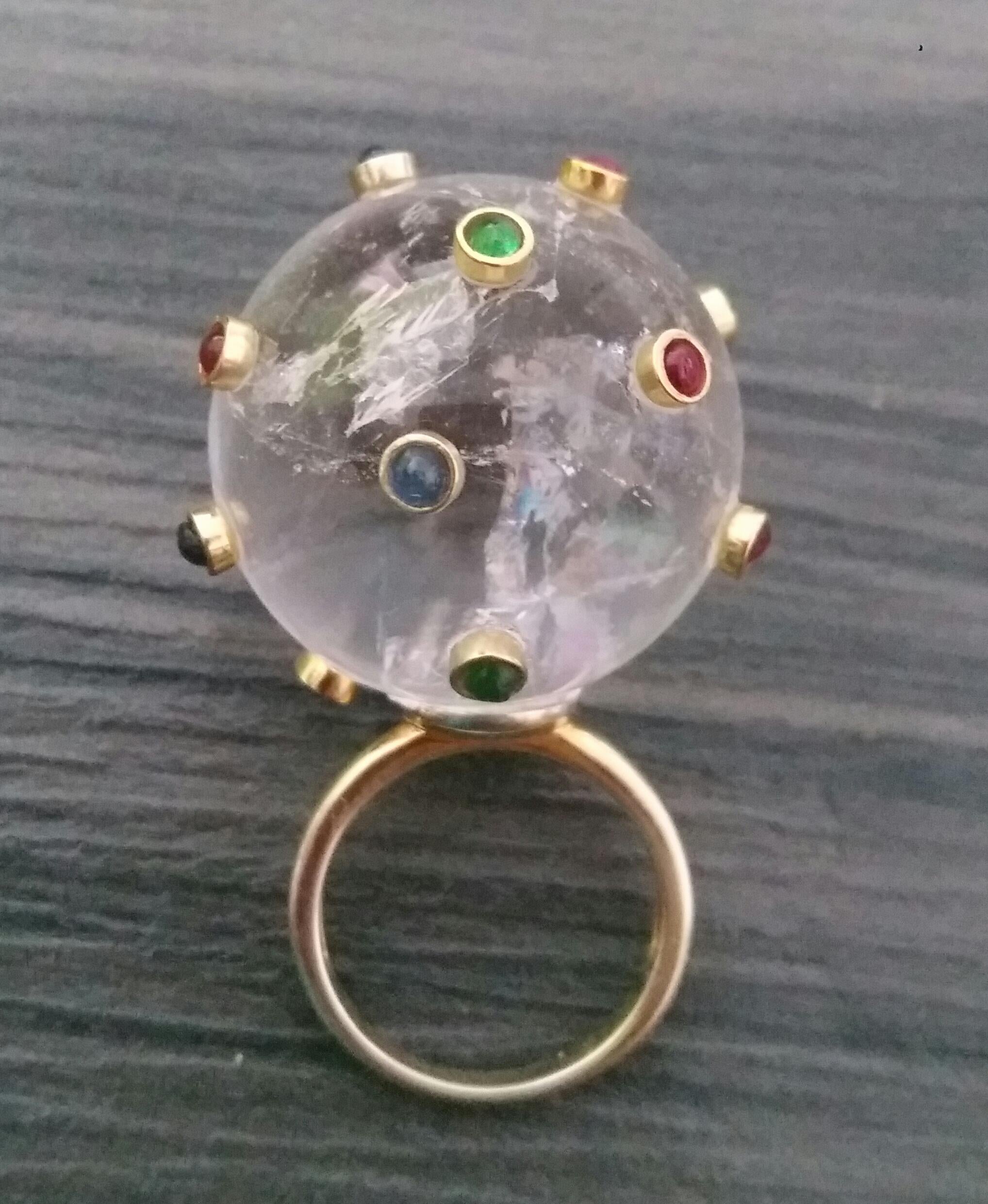 Extremely Stylish and Unique Ring composed by a Natural Quartz  Sphere measuring 27 mm in diameter and weighing 150 Carats ,decorated with 15 small round Rubies,Emeralds and Blue Sapphires set in 14K yellow gold bezels.

In 1978 our workshop started
