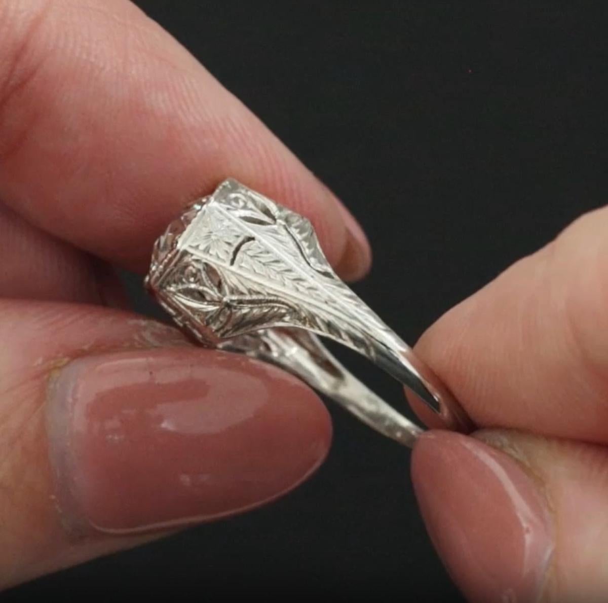 This exquisite vintage engagement ring features a beautifully faceted 1.50 carat old European cut diamond set in a finely crafted platinum setting adorned with delicate floral engravings. A true piece of Art Deco artistry, the ring captures the