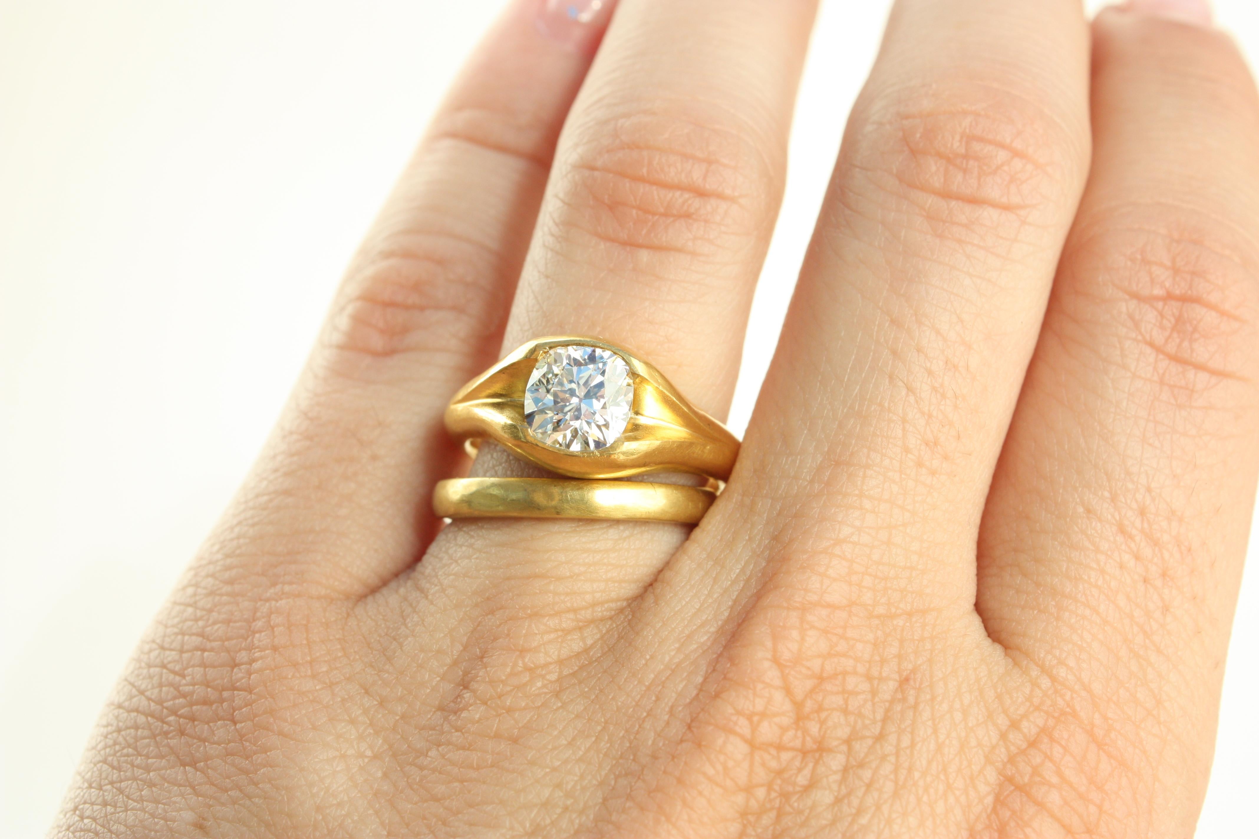 This handcrafted split-shank solitaire ring highlights a rare 1.50ct “new” old mine cut diamond in rich 22K yellow gold. The elegant split band adds a contemporary twist to a timeless design, showcasing Bracken Jewelers' dedication to artistry,