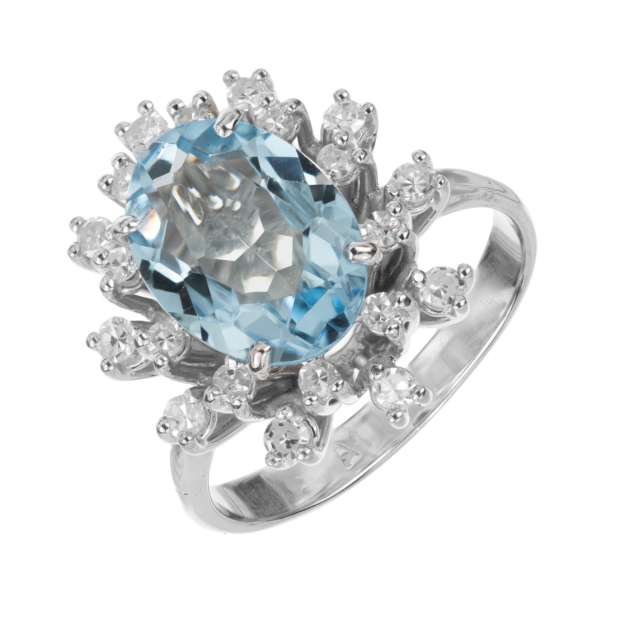 Vintage Mid 1950's Aquamarine and diamond engagement ring. This mid-century ring begins with a 1.50ct oval aquamarine, mounted in a setting crafted in 18k white gold. The aqua is surrounded 20 single cut diamonds in a double halo that adds a touch