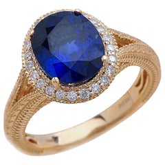 1.50 Carat Oval Cut Blue Sapphire Engagement Ring in 14 Karat Yellow Gold