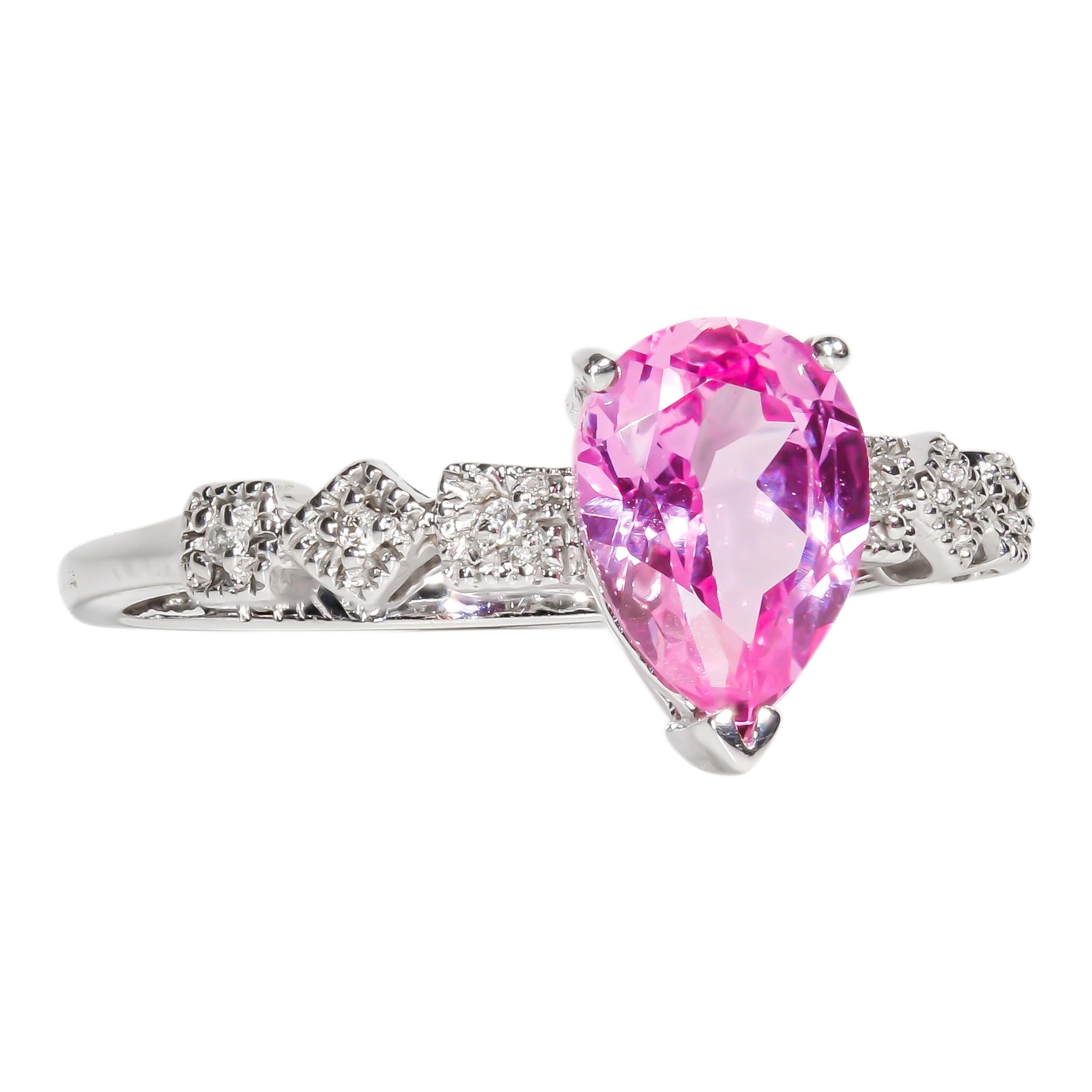 14 karat white gold cocktail ring containing a 1.50 carat prong set pink topaz center stone with six pave set round brilliant diamond side stones. The total weight of the diamond side stones is 0.06 carats.

All new items are guaranteed to be