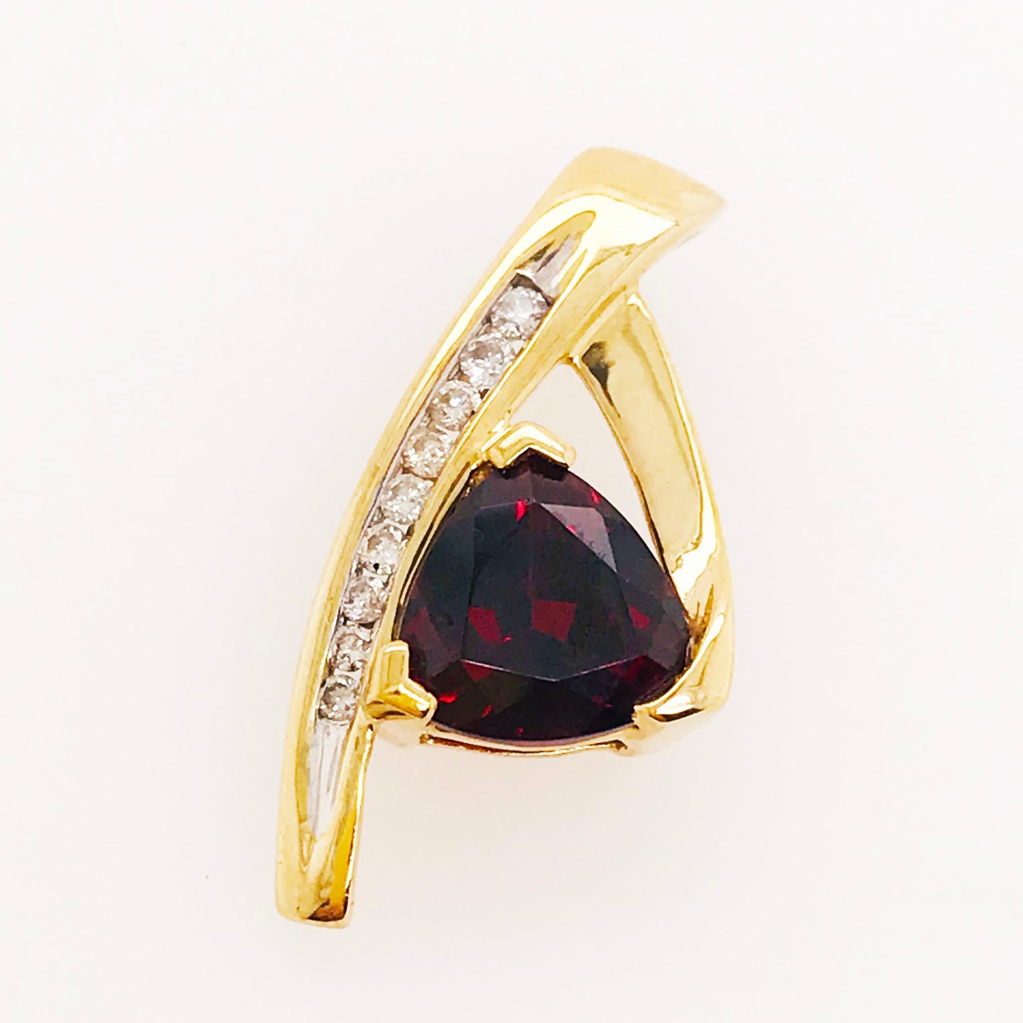 This estate garnet and diamond custom piece is a one of a kind slide pendant. The pendant has a trillion shaped genuine garnet gemstone that has a beautiful bold red color. Framing one side of the garnet gemstone is a diamond row set in white gold.