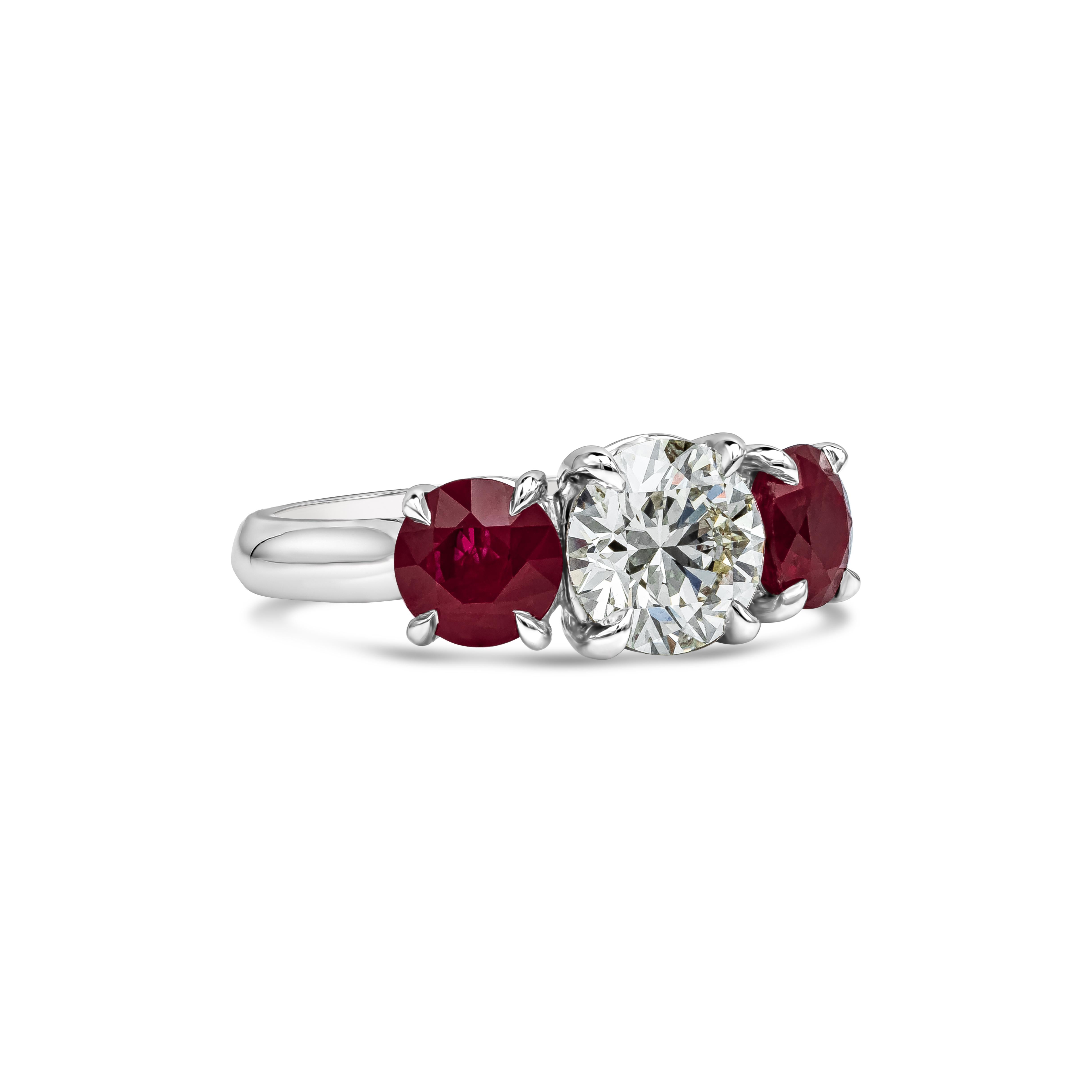 A sparkling 1.50 carats round diamond takes center stage in this ruby and diamond engagement ring. Accenting the center stone are two color-rich rubies set in a four  prongs basket setting and made in platinum. Rubies weigh 2.27 carats total.