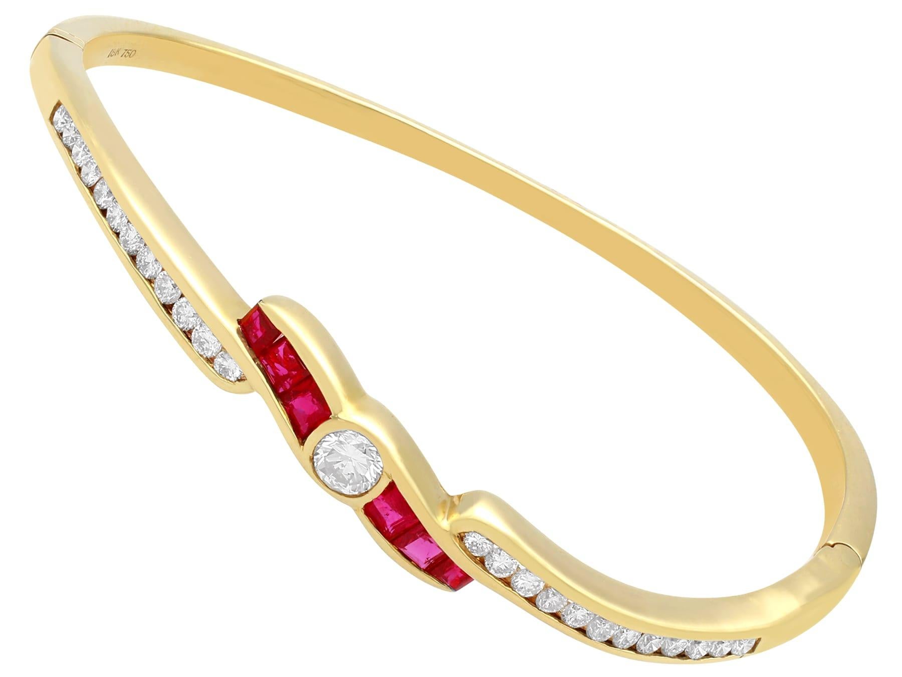 An impressive contemporary 1.50 carat ruby and 1.36 carat diamond, 18 karat yellow gold twist design bangle; part of our diverse gemstone jewelry collections.

This exceptional fine and impressive ruby and diamond bangle has been crafted in 18k