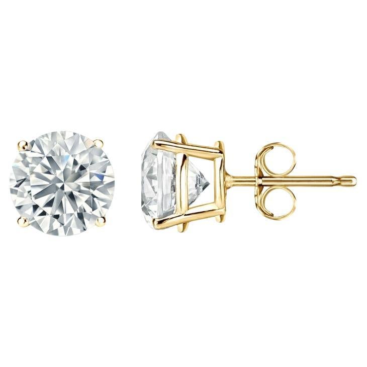 Stunning 14 Karat yellow gold handmade earrings featuring 2 round brilliant cut diamonds weighing 1.50 carat total I-J color and I1/I2 clarity. These gorgeous earrings are classic and timelessly elegant.