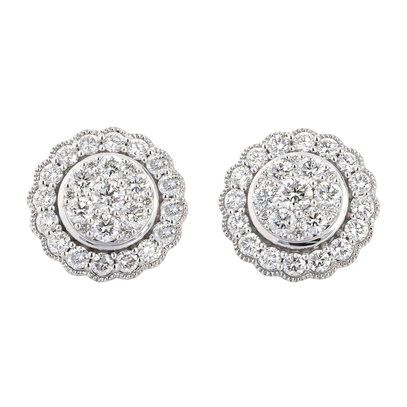 14 karat white gold diamond stud earrings with diamond halo. The total diamond carat weight is 1.50 and the stones are approximately H-I color (near colorless) and VS/SI (eye-clean) clarity. 
The earring are designed to give the illusion of 1 large