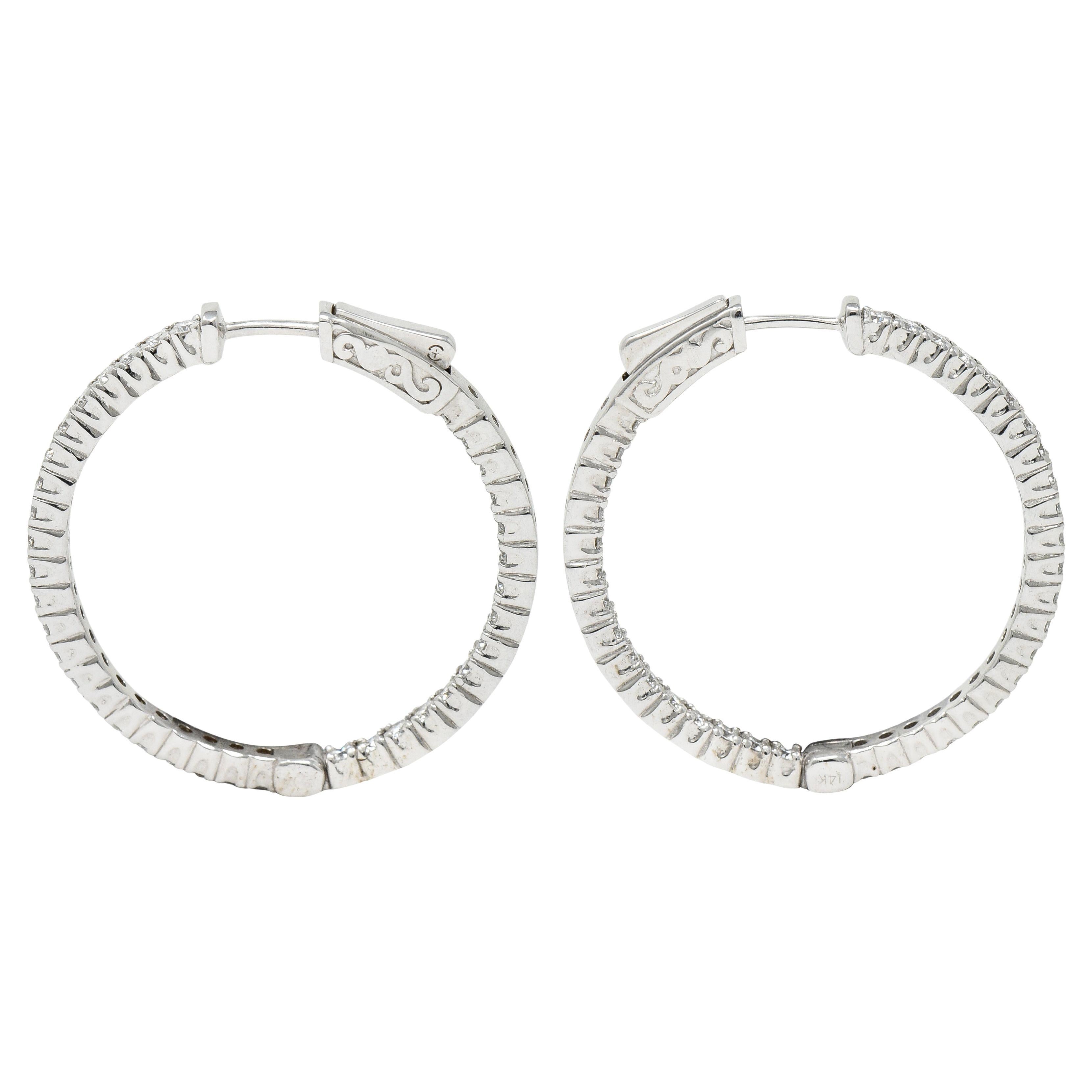 Inside/outside style huggie hoop earrings

With individually set round brilliant cut diamonds

Weighing in total approximately 1.50 carats - G to H color with overall VS clarity

Opens on a hinge via presser revealing posts

Inscribed with carat