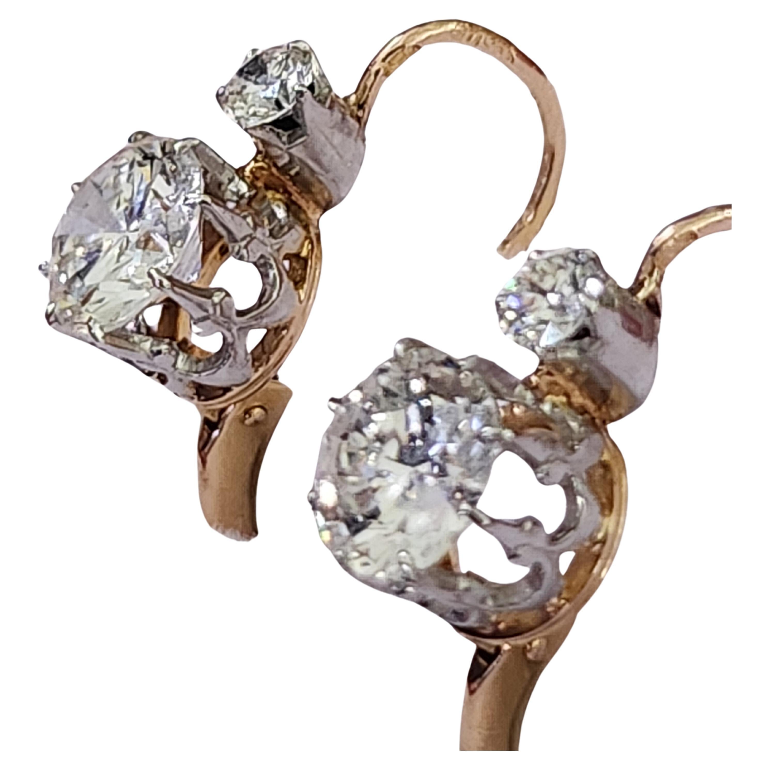 French 18k gold earrings centered with 2 old european cut diamond G color white vvs clearity excellent spark total weight 1.50 carats topped with 0.20 ct diamonds earrings made in france 1910s hall marked with french eagle gold standard total