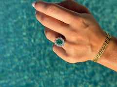 1.50 Carats oval Emerald and diamond cluster ring