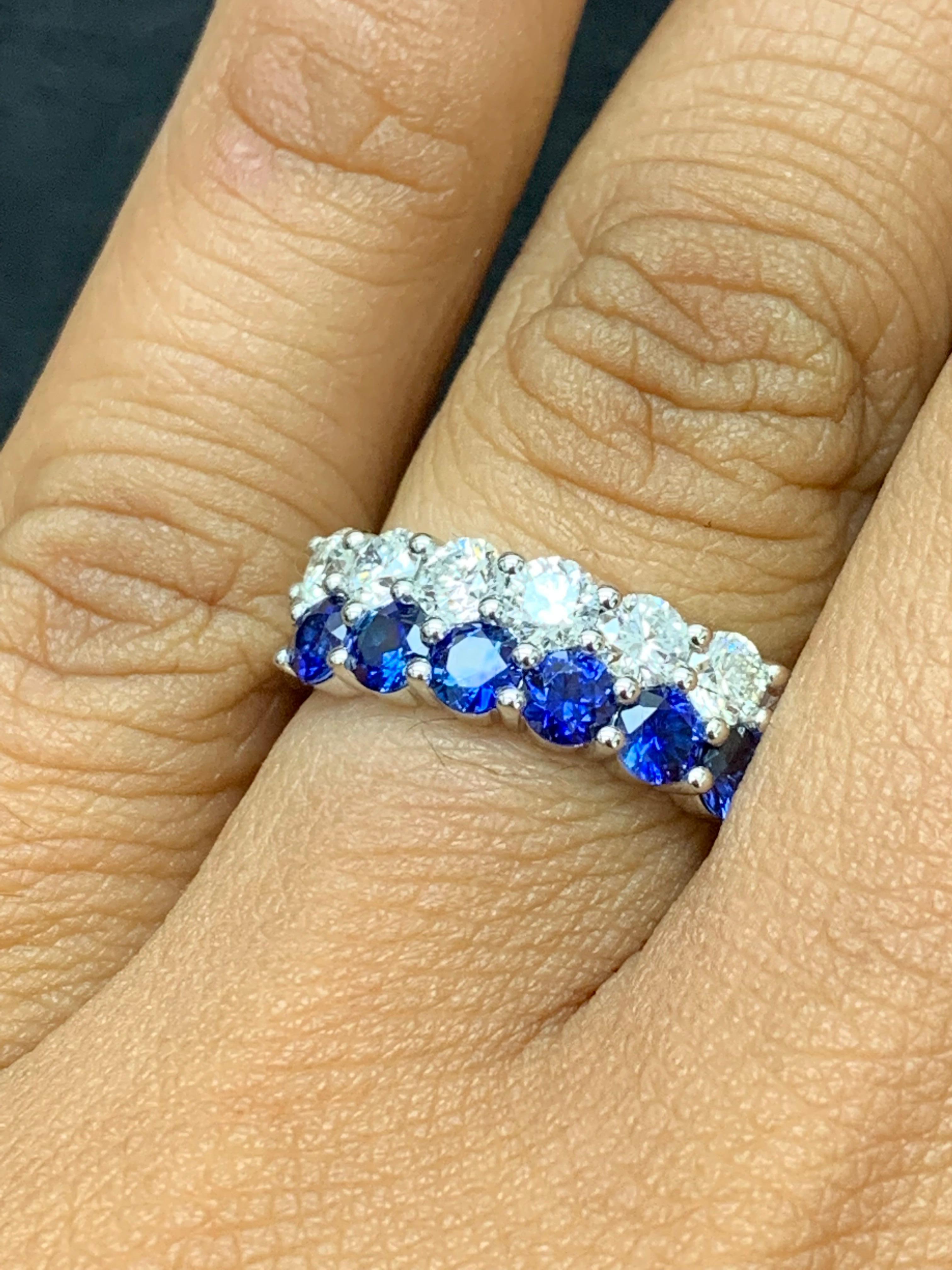 A unique and fashionable ring showcasing two rows of round-shape 9 blue sapphires and 10 diamonds, set in a band design. Blue Sapphires weigh 1.50 carats and Diamonds weigh 1.49 carats total. A brilliant and masterfully-made piece.

Style available