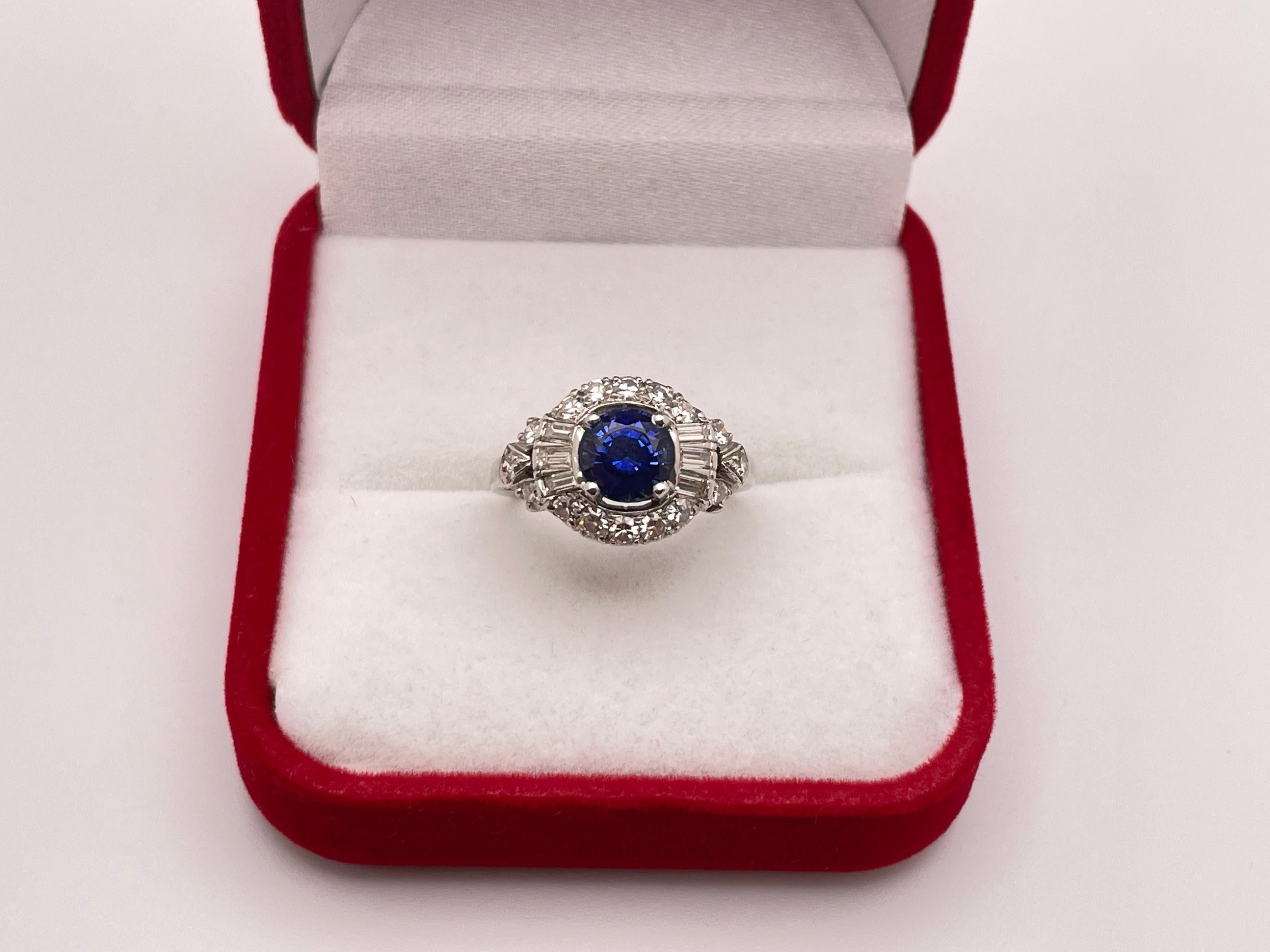 An original Art Deco handmade sapphire diamond platinum engagement ring. Mounted with a beautiful natural unheated round cut blue sapphire weighing approximately 1.50 CT. On either side of the sapphire are three baguette cut diamonds (total of six),