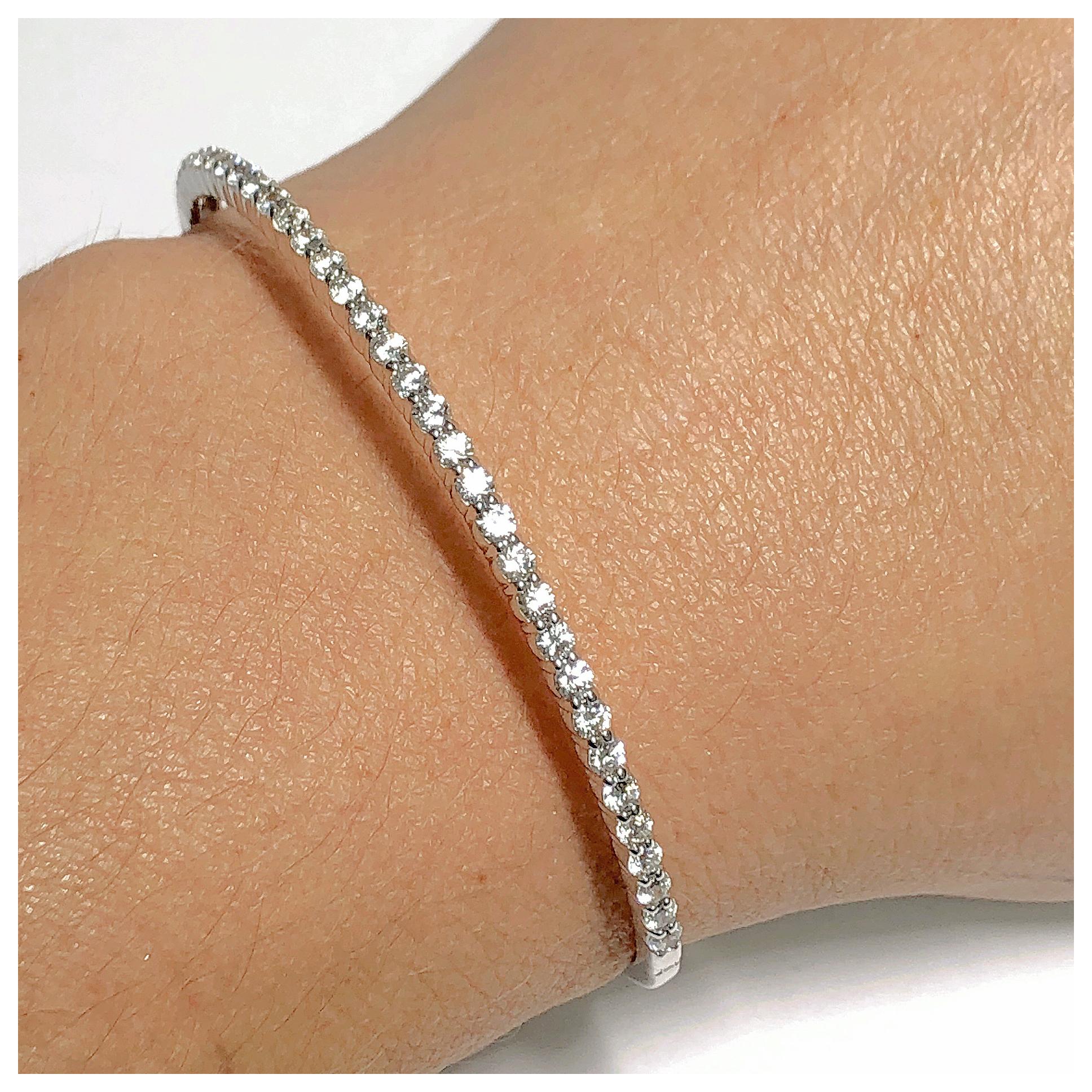 This 14kt. bangle bracelet contains 1.50 ct total weight of G color SI clarity round diamonds that reach halfway around the top of the bracelet. If you don't see something, say something! We are a custom jewelry manufacturer in the heart of the