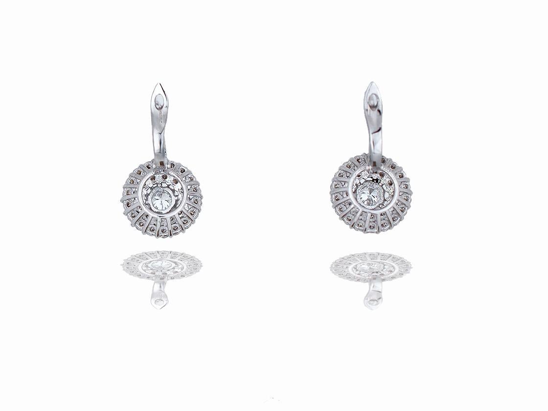 These classic diamond earrings contain the following.  These drop earrings have an amazing look, the center stone is accented by over sixty round brilliant diamonds and a total diamond carat weight of 1.50 carats.  The earrings are cast from 18k