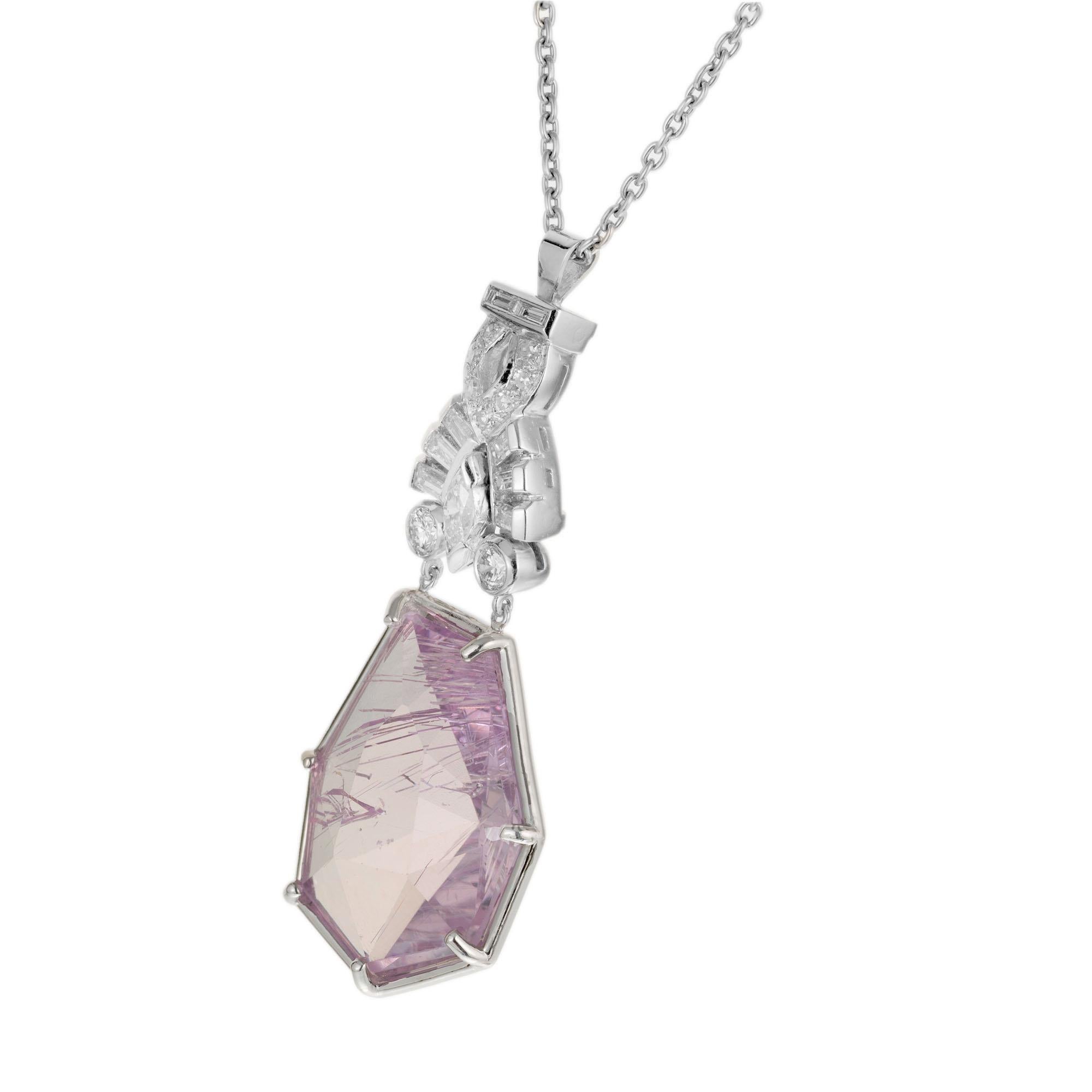 1930's Art Deco Kunzite and diamond pendant necklace. 15.00ct free form geometric natural shape rose cut Kunzite with rutile needles in a platinum setting with 8 step cut baguette,  9 round and 1 marquise cut accent diamonds. 18 inch chain. A unique