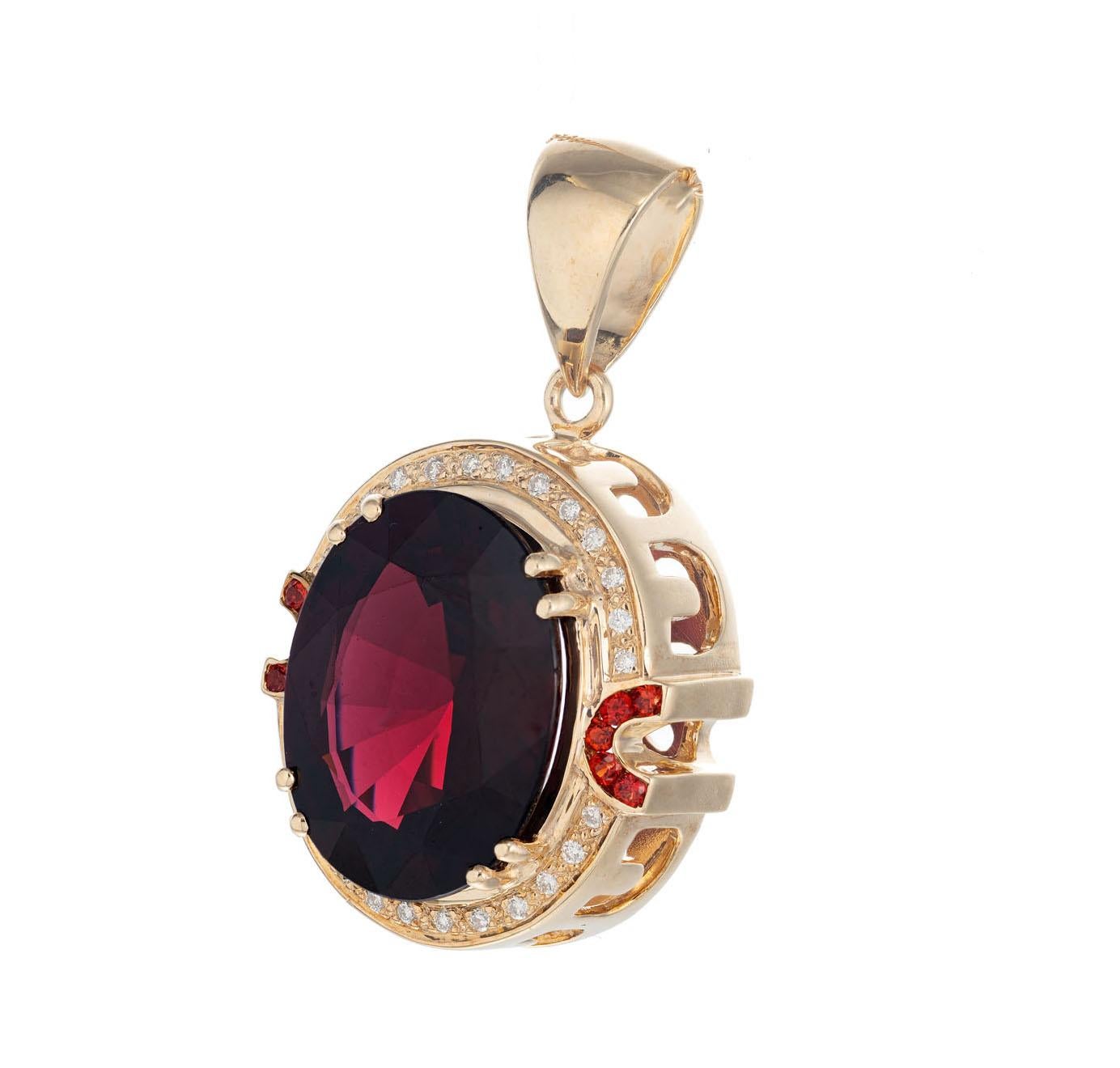 15.00ct garnet pendant with a halo of full cut diamonds and round red Rubies. Pierced side gallery and bottom gallery. Chain not included. 

1 oval 18.6 x 14.4mm deep red Garnet, approx. total weight 15.00cts
26 round diamonds, approx. total weight