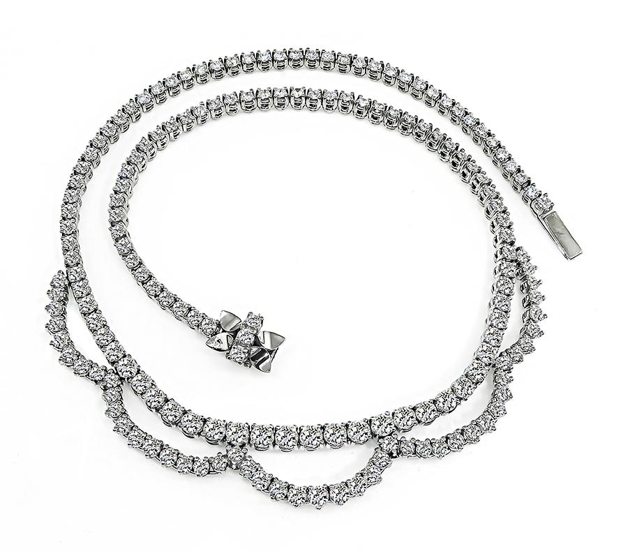 This is a stunning 18k white gold necklace. The necklace is set with sparkling round cut diamonds that weigh approximately 15.00ct. The color of these diamonds is H with VS2-SI1 clarity. The necklace measures 16 inches in length and weighs 54.5