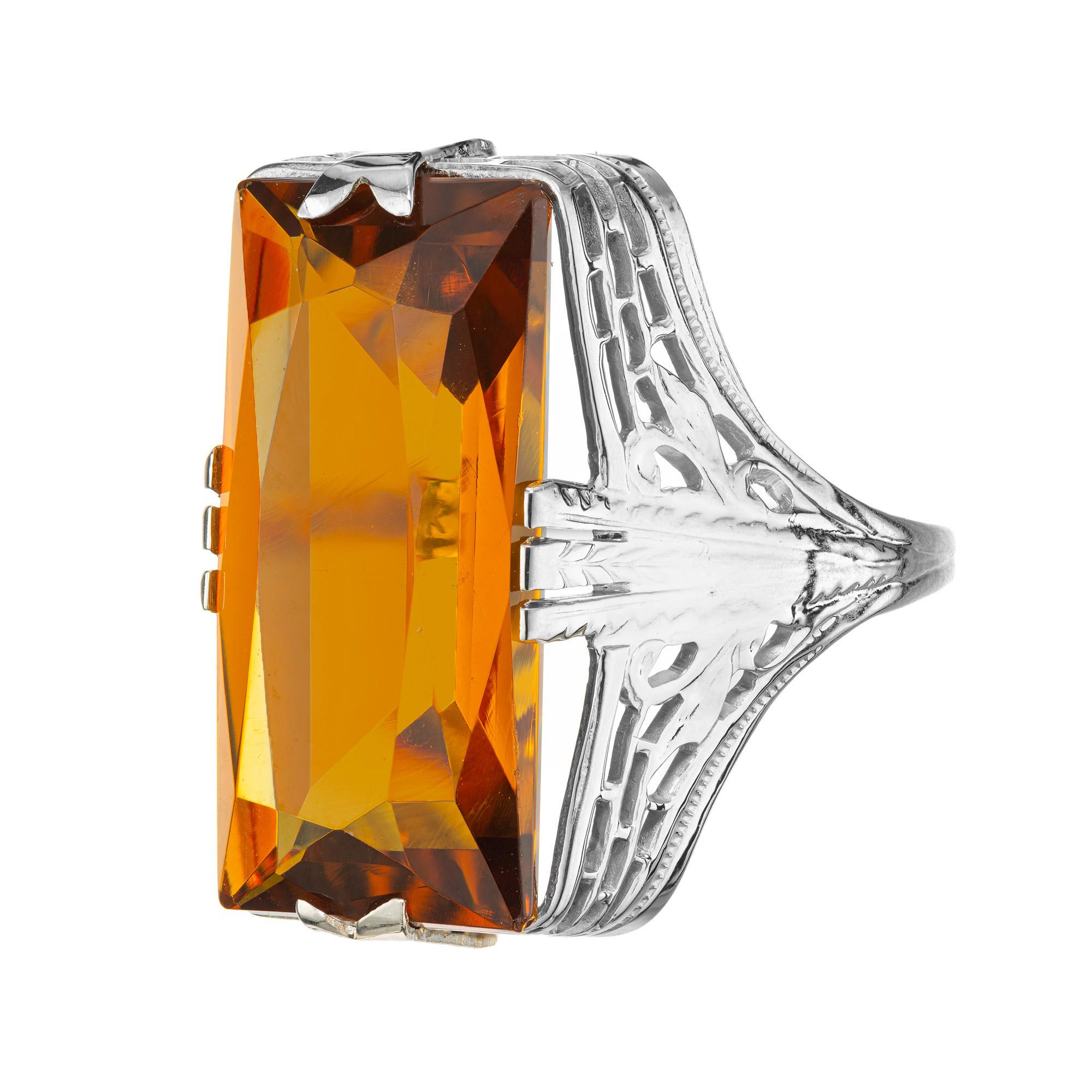 Take a step back in time with this exquisite original late art deco 14k white gold filigree ring set with a 15.00 carat rectangular cut natural orange yellow citrine. Circa 1940's. This gorgeous cocktail ring is a true statement piece with
