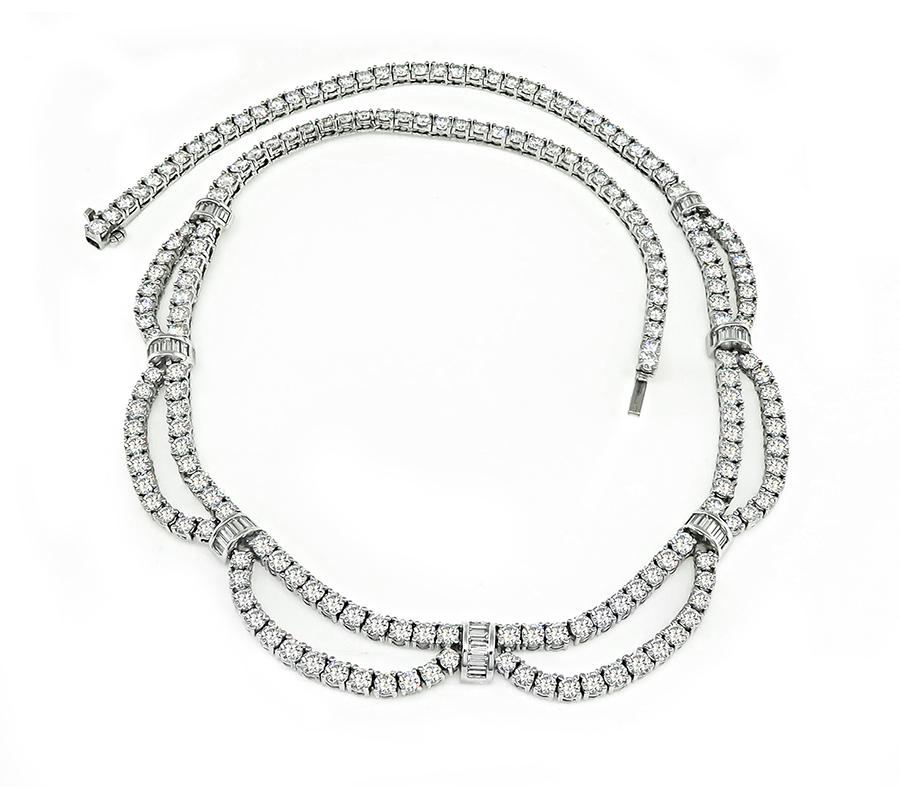 This is an elegant 18k white gold necklace. The necklace is set with sparkling round and baguette cut diamonds that weigh approximately 15.02ct. The color of these diamonds is F-G with VS clarity. The necklace measures 15 3/4 inches in length and