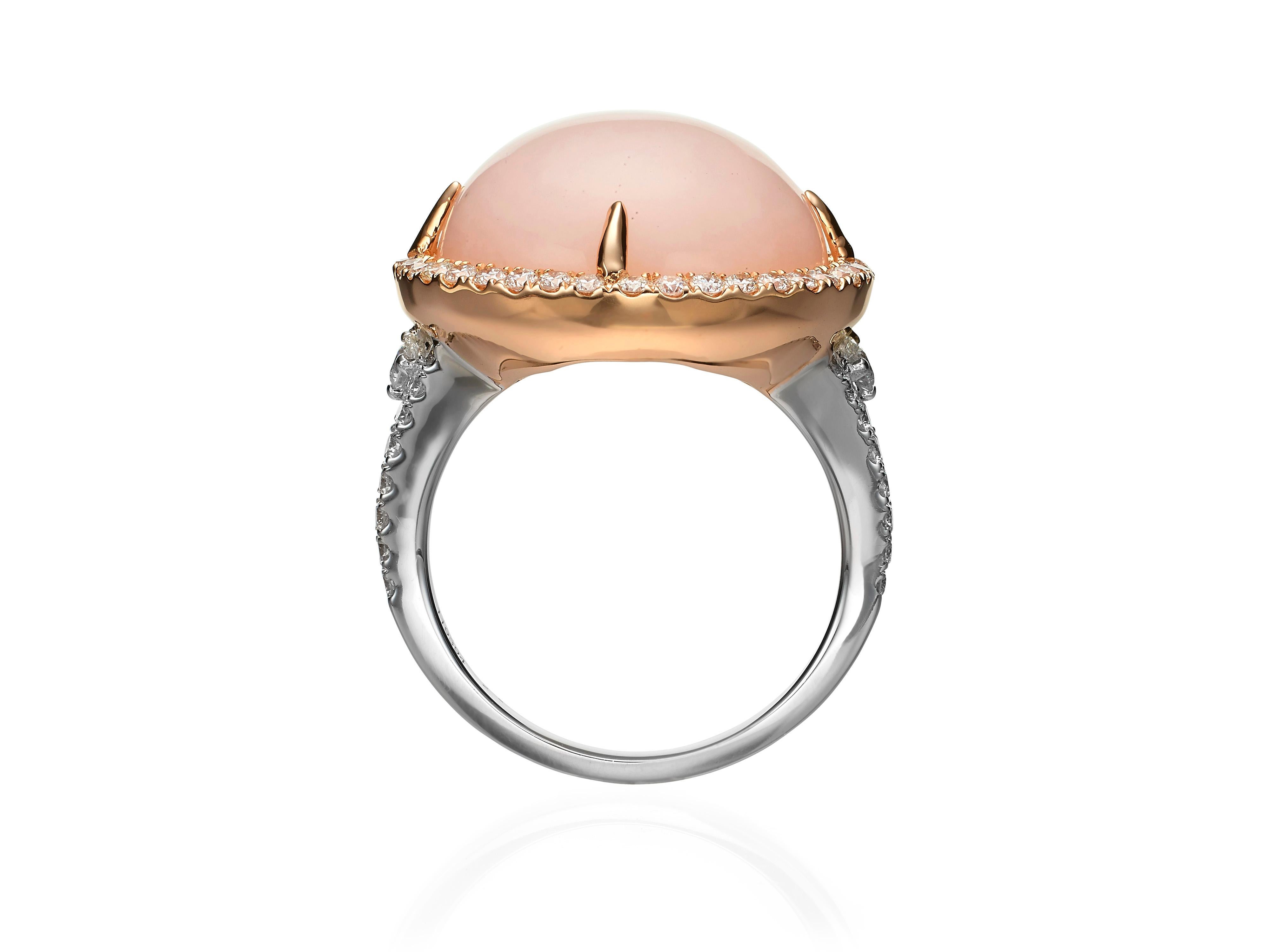 Crafted from 18K rose and white gold, this cocktail ring features a 13.91 carat pink opal surrounded by a halo of white diamonds set in rose gold and white diamonds set in white gold on the band (totaling 1.12 carats).  Currently a ring size US 8.5.