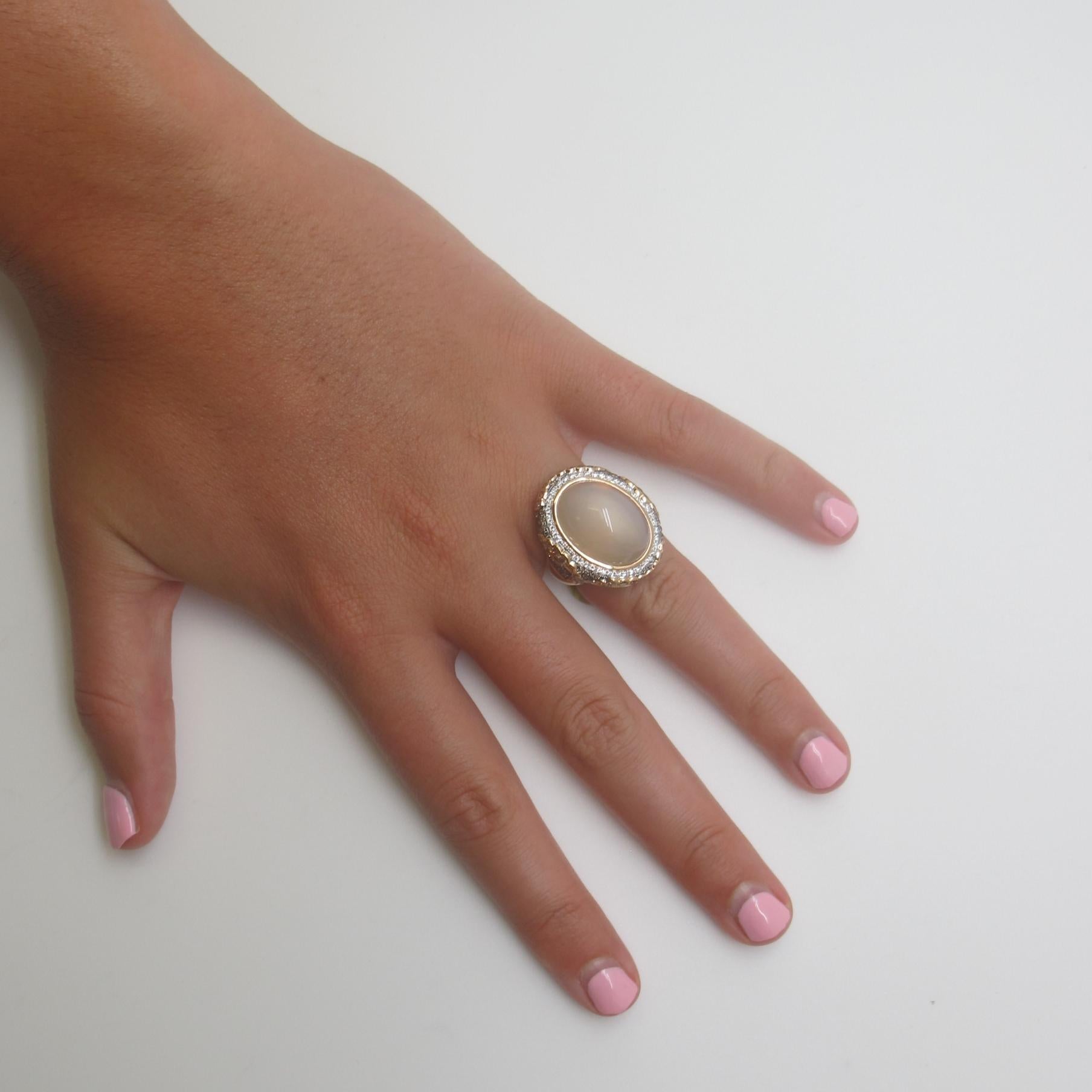 A large, oval moonstone (15.05cts) is featured in this ring of 18 karat rose gold.  It is a translucent 
