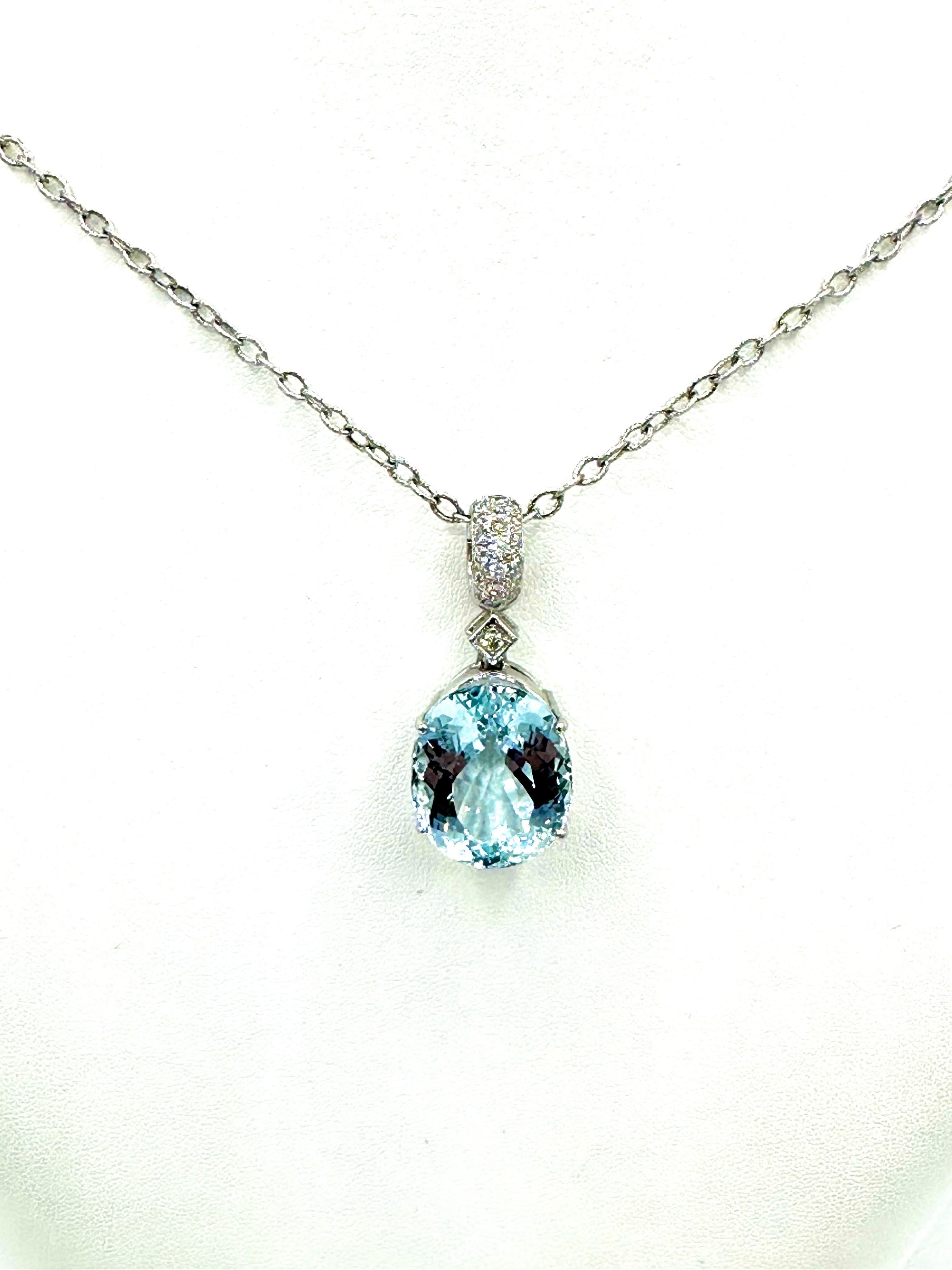 A mesmerizing blue Aquamarine and Diamond pendant!  The 15.08 carats Aqua is set in a four prong basket setting, suspended from a single Diamond station and pave Diamond bale.  The Diamond and pave Diamonds have a total weight of 0.34 carats.  The