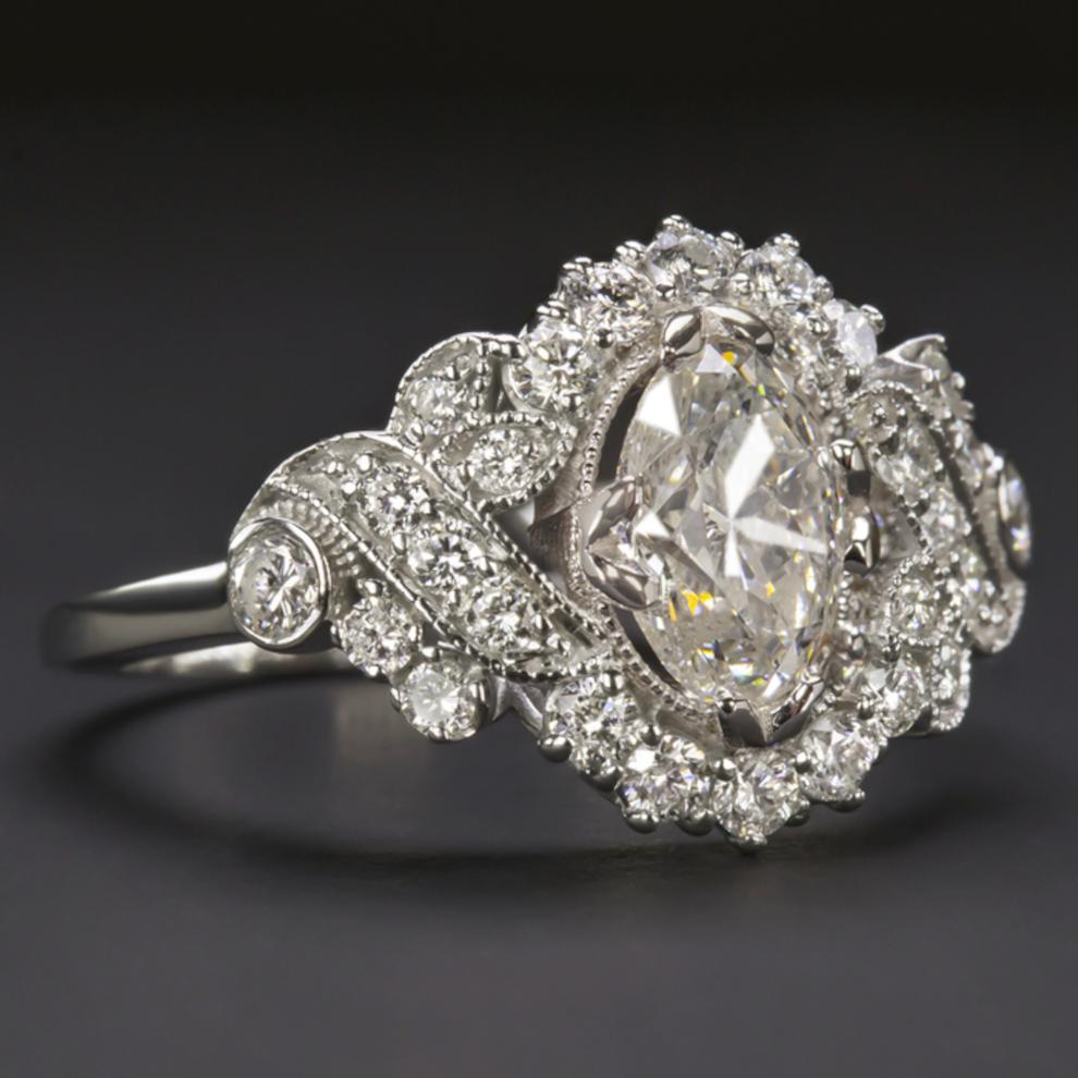 Gorgeous diamond engagement ring. The central oval cut diamond is brilliant white and clean-eyed, offers extraordinary brilliance and large size and weighs 0.96 carats. The soi center stone is set in a beautiful diamond-encrusted frame that has a