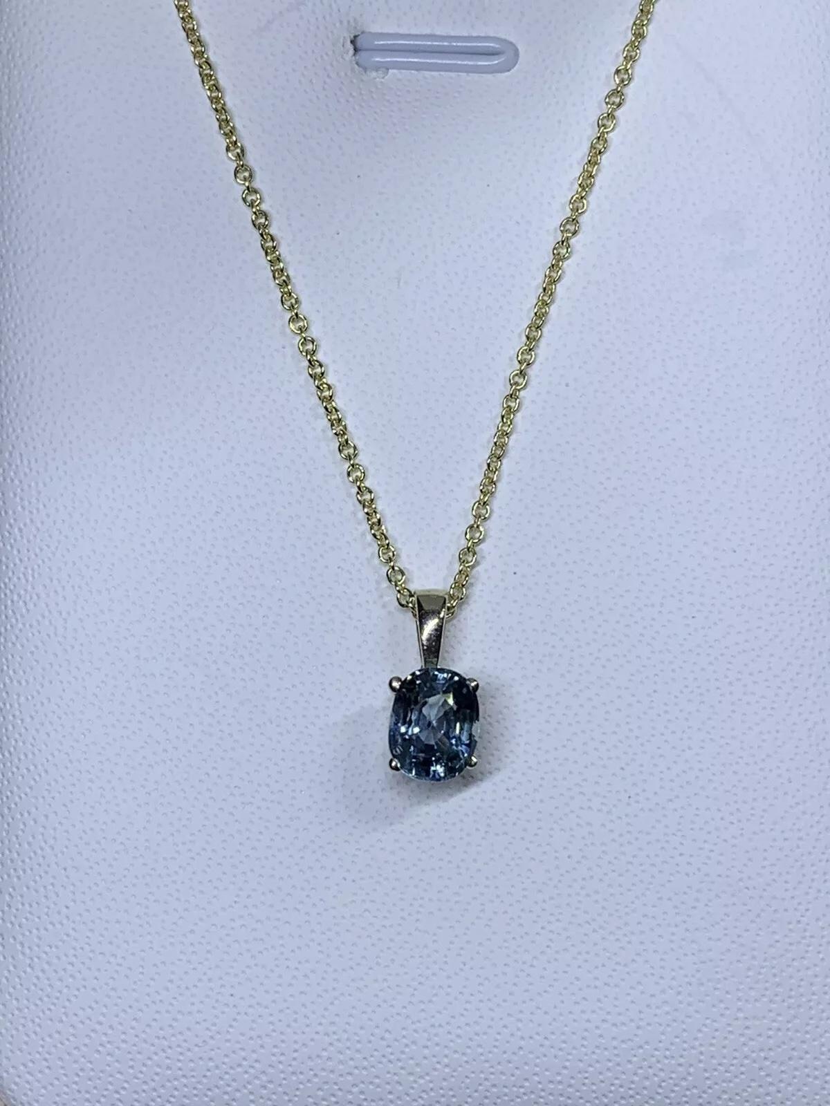 1.50ct Sapphire Chunky Solitaire Pendant Necklace In 18ct Yellow Gold
1.50ct total weight sapphire natural untreated gemstone 
Beautiful bluish teal sapphire colour vivid intense. 
oval shaped excellent cut set in four claw setting 18k white