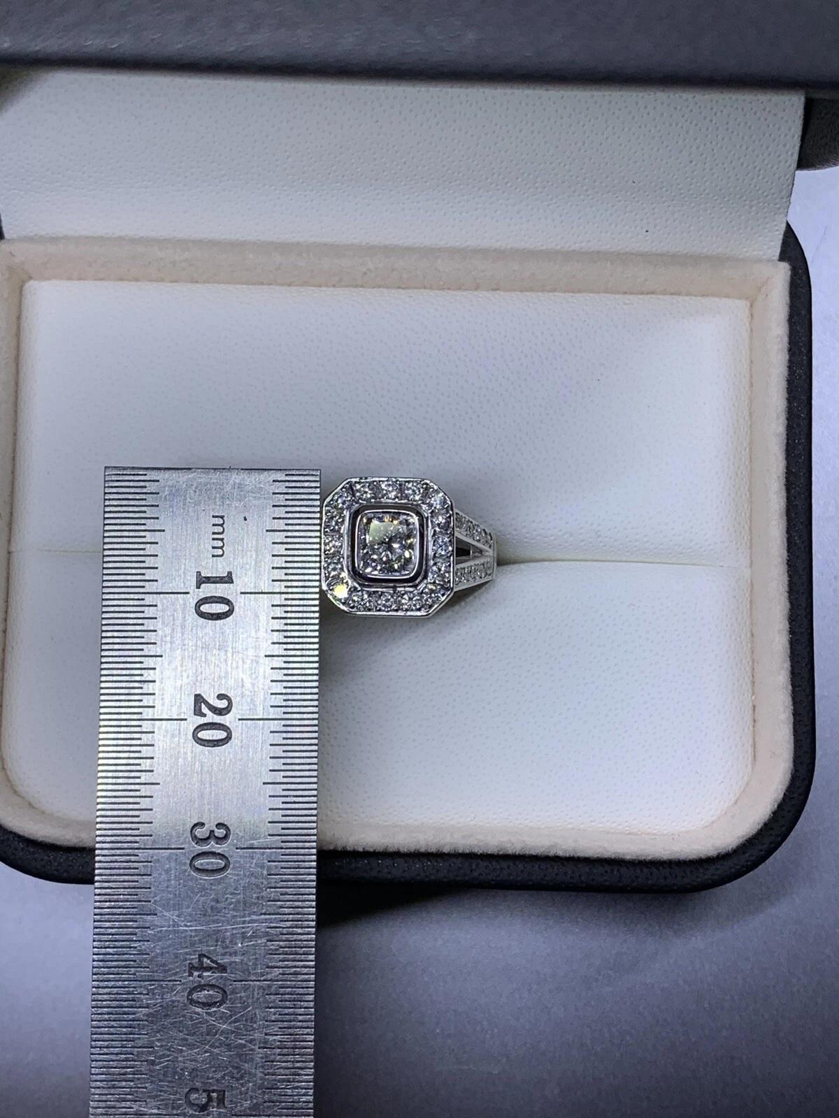 1.50ct cushion diamond with halo antique engagement ring in 18k gold Split Band.

Classic split band cushion diamond with halo around engagement ring in 18ct white gold 

Centre diamond weight 0.70ct G colour VS1 clarity

Hallmarked.

Halo and