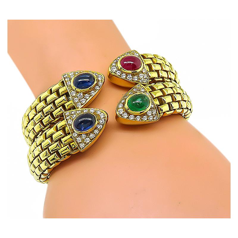 This is an elegant 18k yellow gold bangle set. The bangles feature lovely cabochon sapphires, ruby and emerald that weigh approximately 4.00ct, 2.00ct and 1.50ct respectively. The precious stones are accentuated by sparkling round cut diamonds that